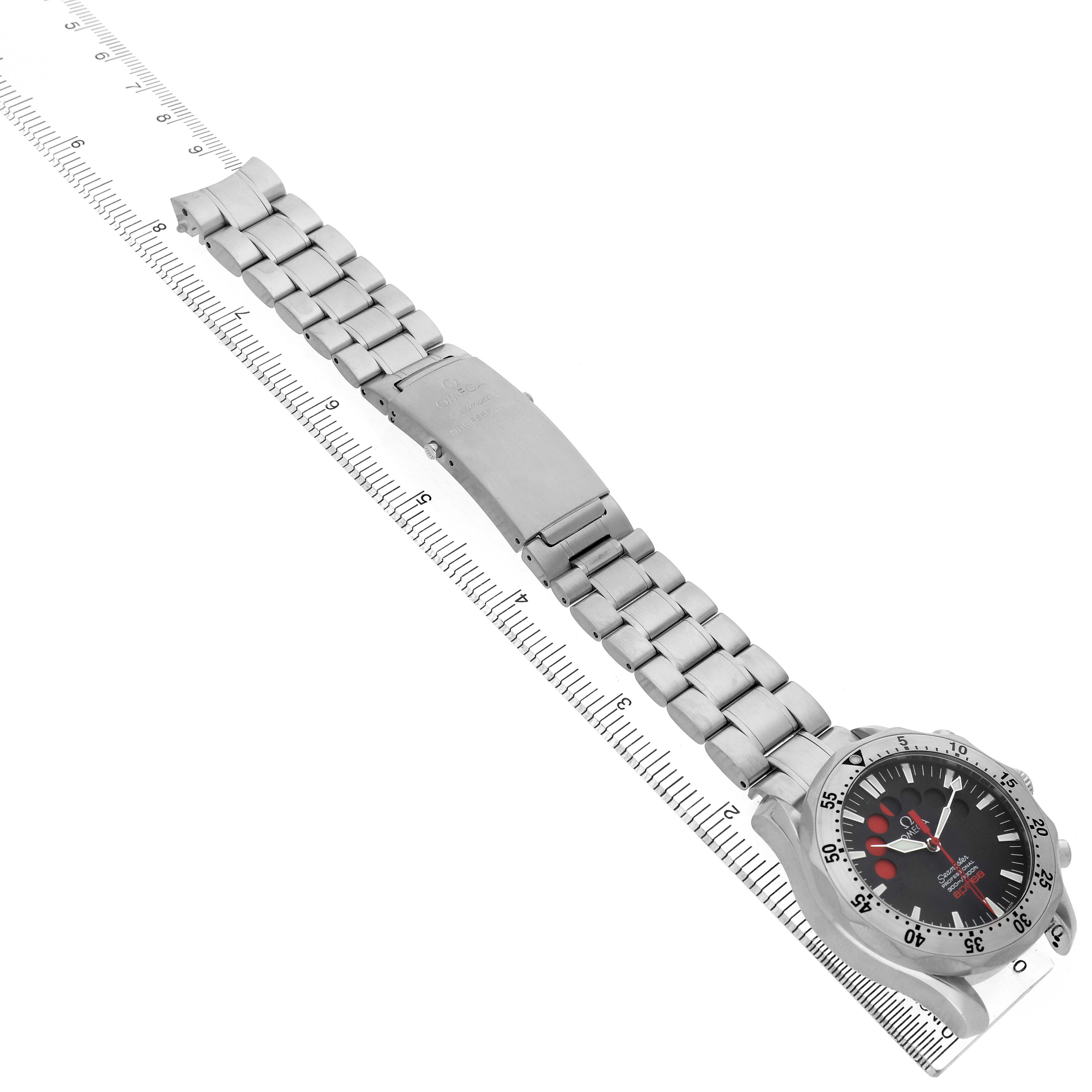 The Omega Seamaster 2595.50.00 Men's Stainless Steel Black Dial watch is shown at an angle, displaying the face, bezel, and metal bracelet alongside a ruler for scale.