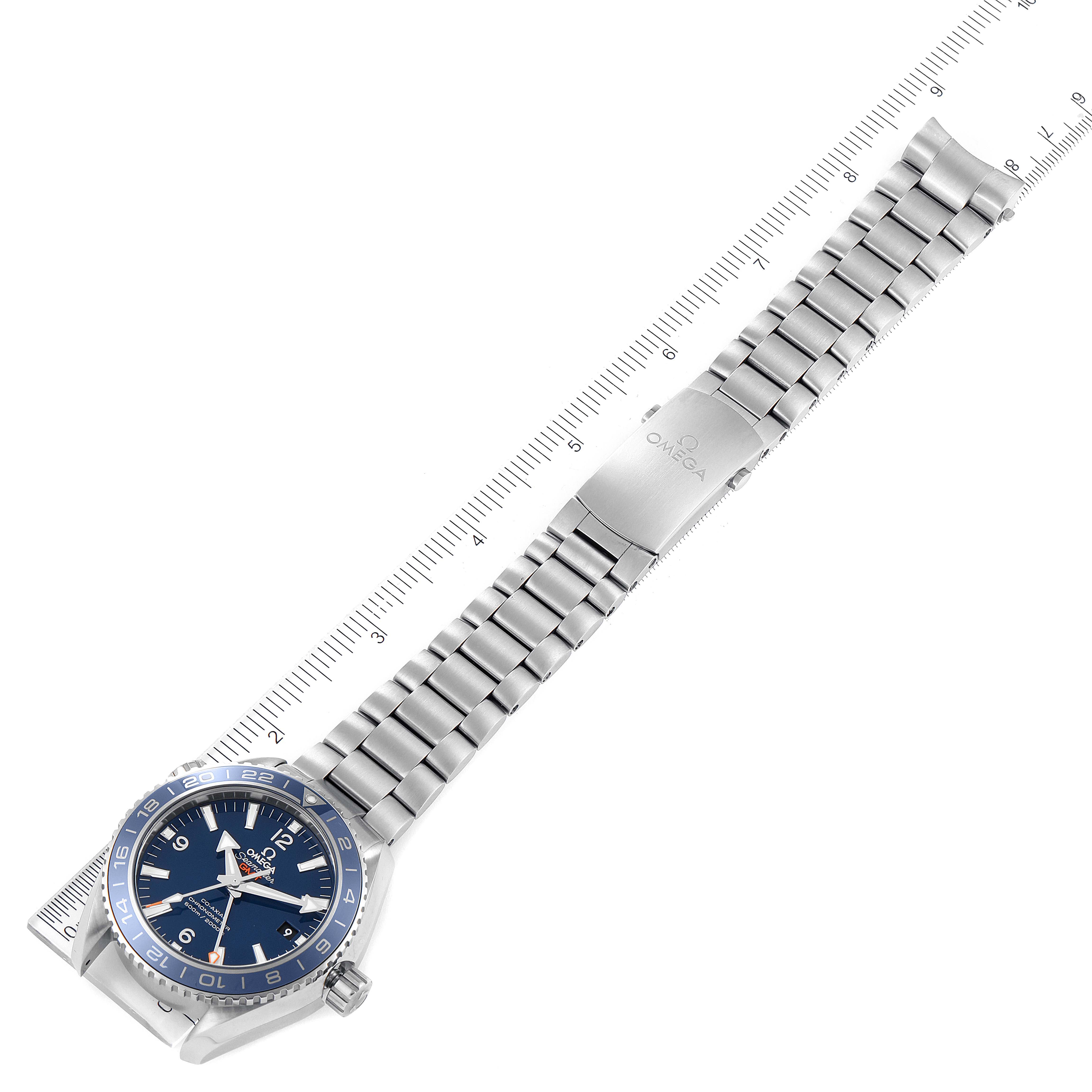 The image shows an Omega Planet Ocean 232.90.44.22.03.001 Men's Platinum Blue Dial 232.90.44.22.03.001 Men's Platinum Blue Dial watch laid flat, highlighting the blue dial, bezel, and metal bracelet with a ruler for measurement.