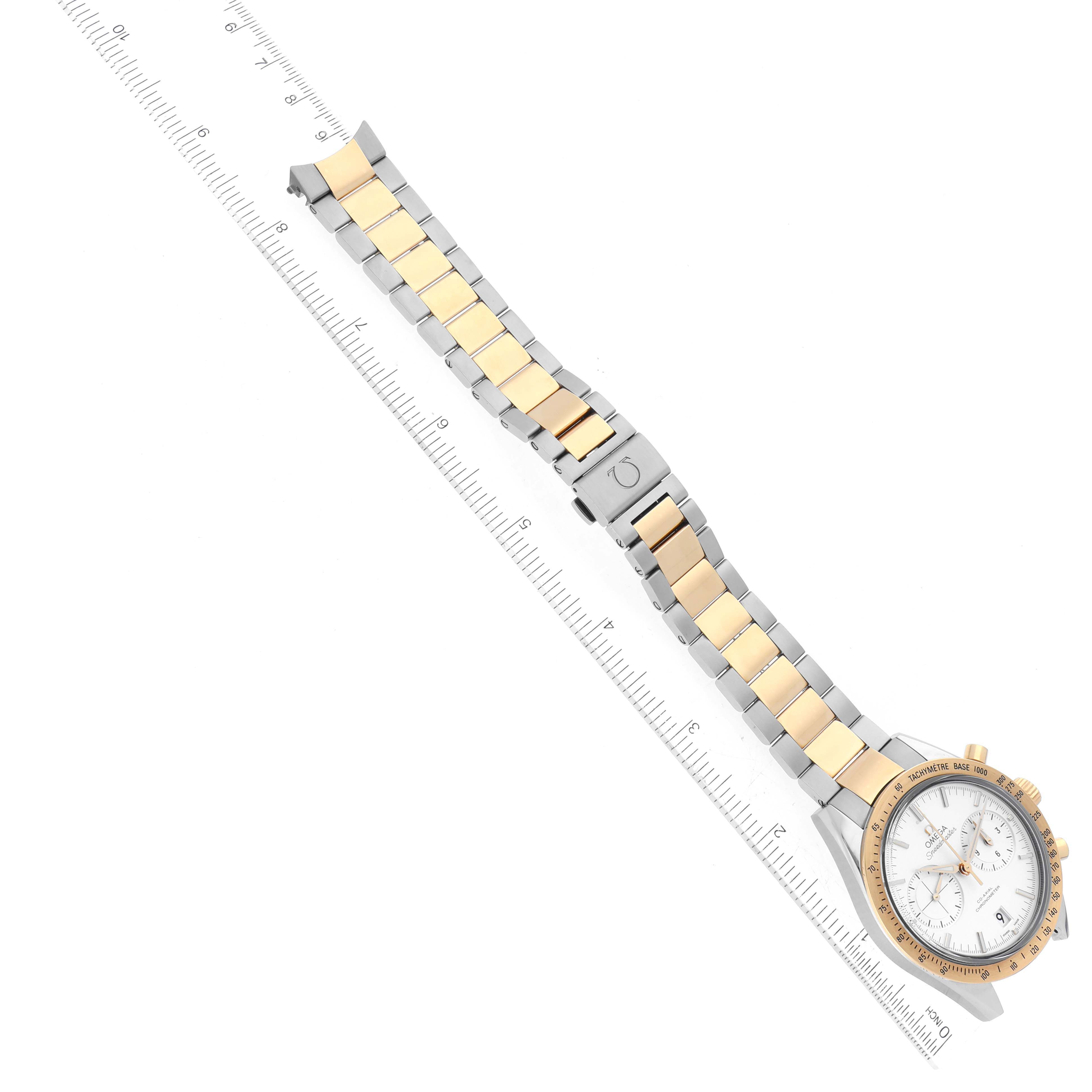 The image shows an Omega Speedmaster 331.20.42.51.02.001 Men's Steel and Gold (two tone) Silver Dial 331.20.42.51.02.001 Men's Steel and Gold (two tone) Silver Dial watch laid flat, highlighting the face, bezel, and two-tone bracelet with a ruler for scale.