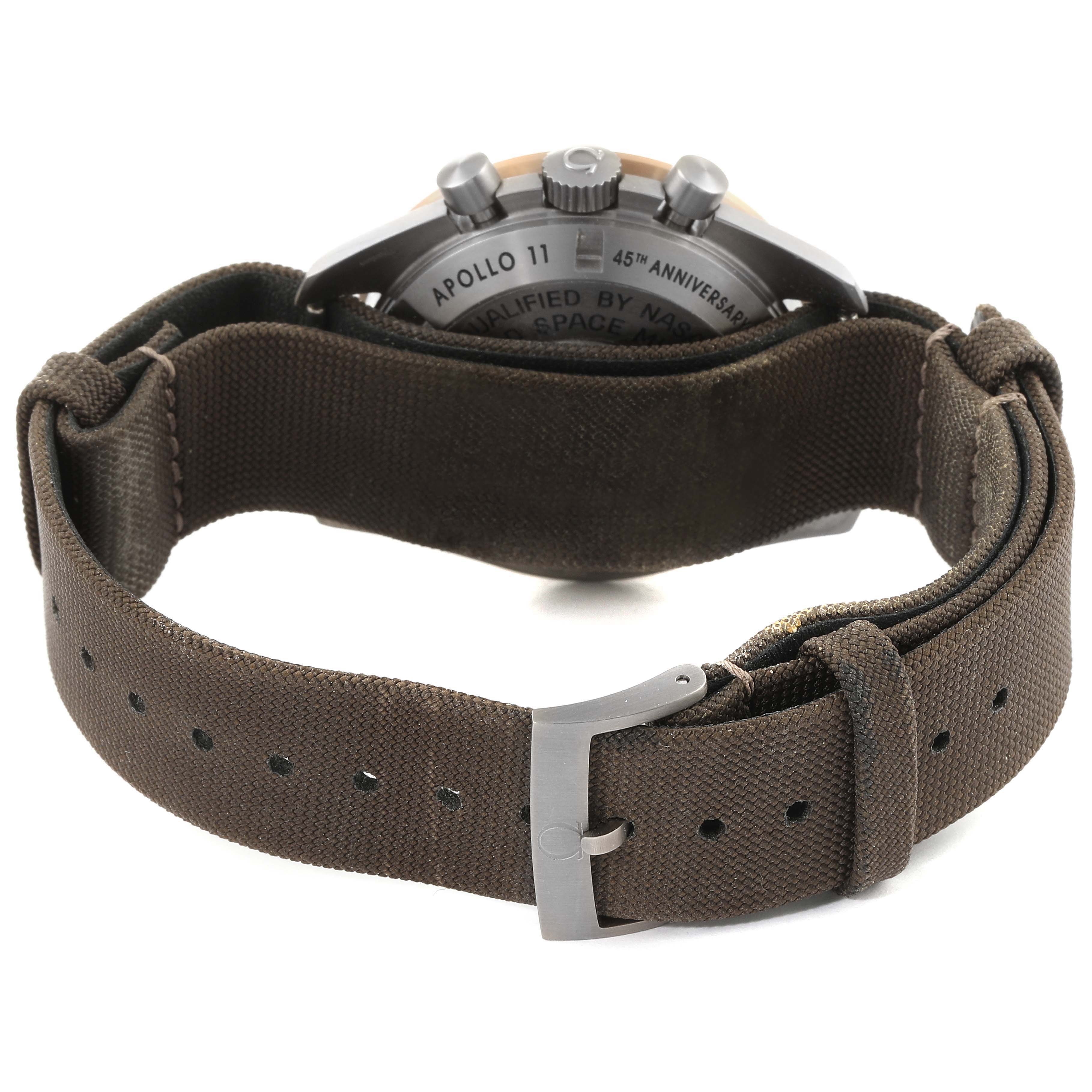 This image shows the back and clasp of an Omega Speedmaster 311.62.42.30.06.001 Men's Titanium Grey Dial 311.62.42.30.06.001 Men's Titanium Grey Dial watch with a brown fabric strap.