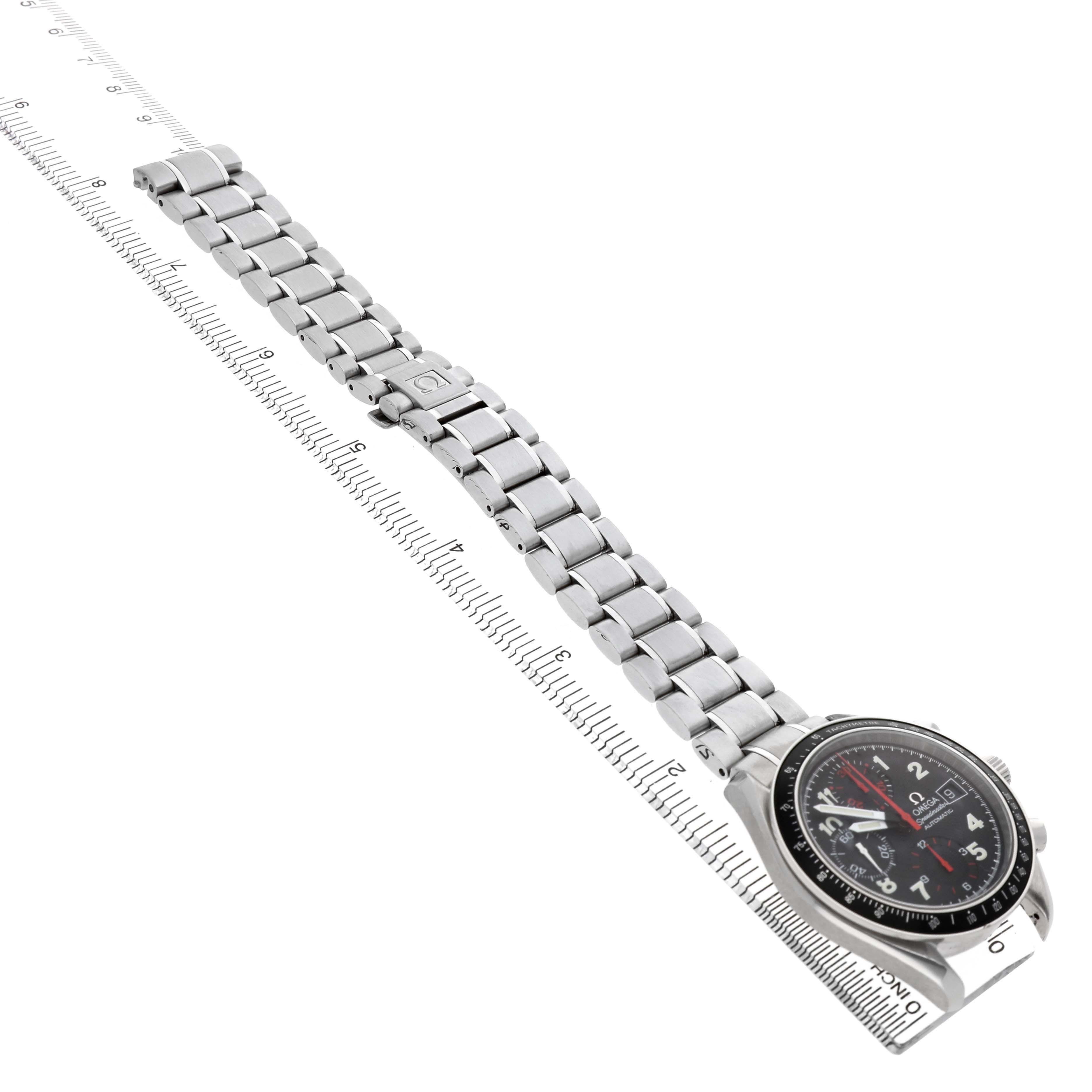The Omega Speedmaster 3813.53.26 Men's Stainless Steel Black Dial watch is shown diagonally with a clear view of the face, bezel, bracelet, and clasp, positioned alongside a ruler.
