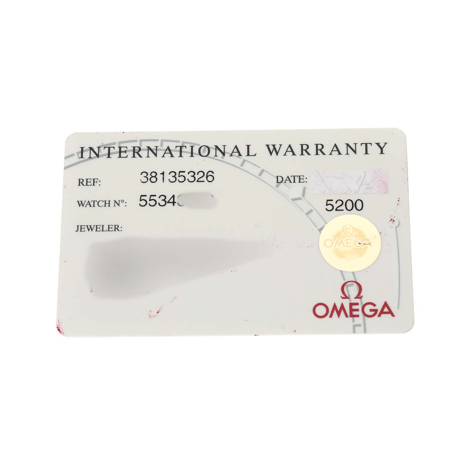 The image shows an Omega Speedmaster 3813.53.26 Men's Stainless Steel Black Dial International Warranty card from a top-down angle.