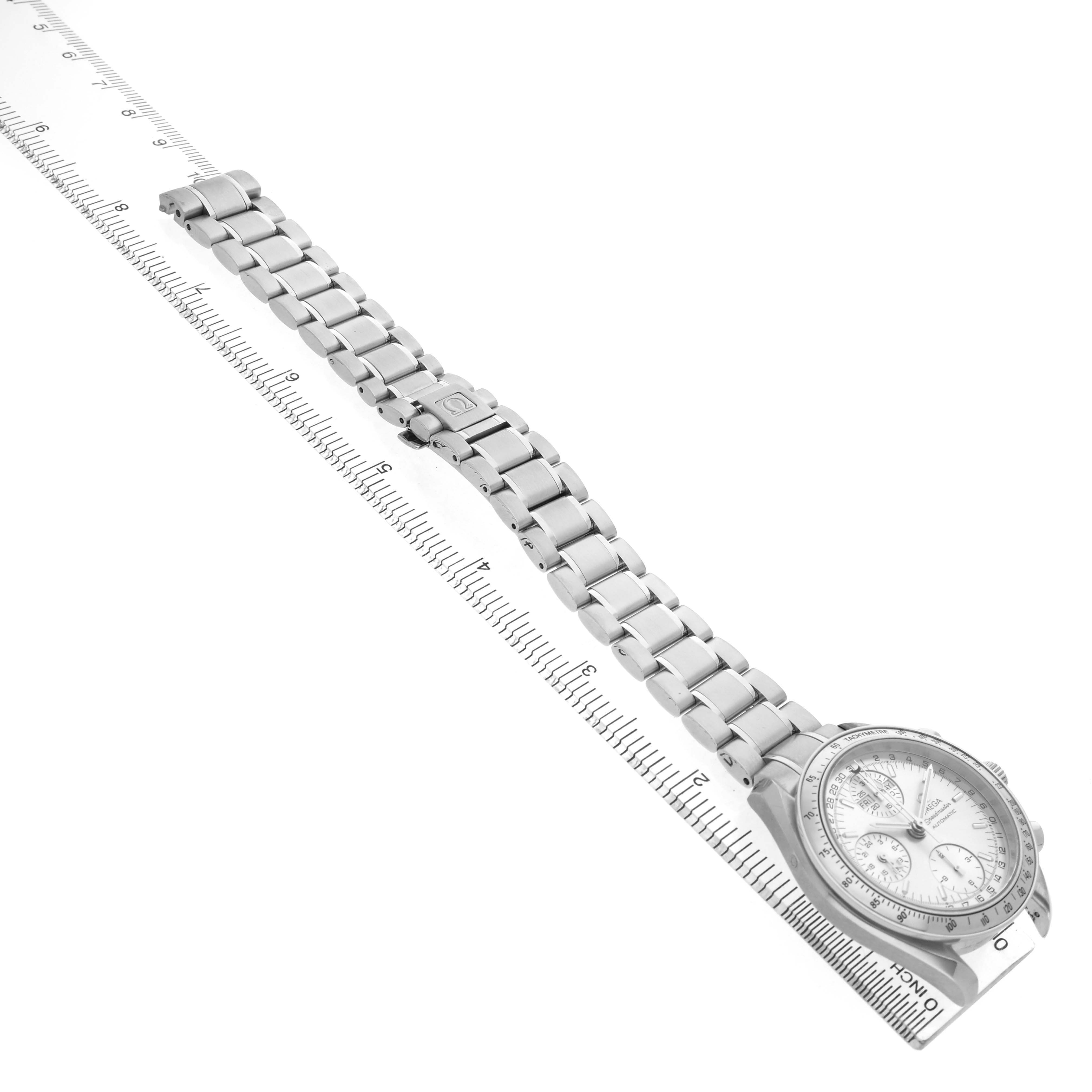 The Omega Speedmaster 3523.30.00 Men's Stainless Steel Silver Dial watch is shown from a top-down angle, highlighting the face and metal bracelet alongside a ruler for scale.
