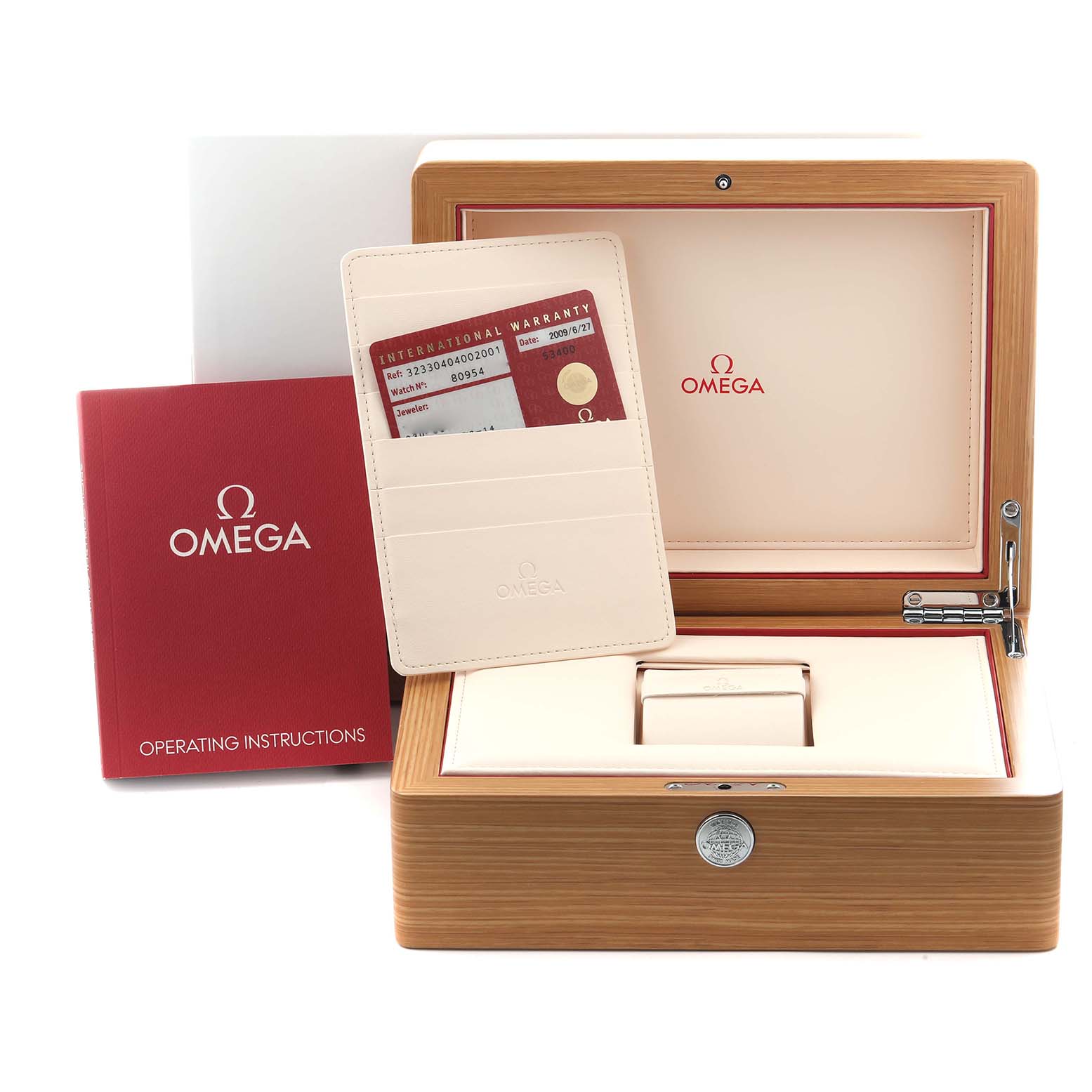 The image shows an Omega Speedmaster 323.30.40.40.02.001 Men
s Stainless Steel White Dial 323.30.40.40.02.001 Men
s Stainless Steel White Dial watch box and accessories including the warranty card and operating instructions, viewed from the front.