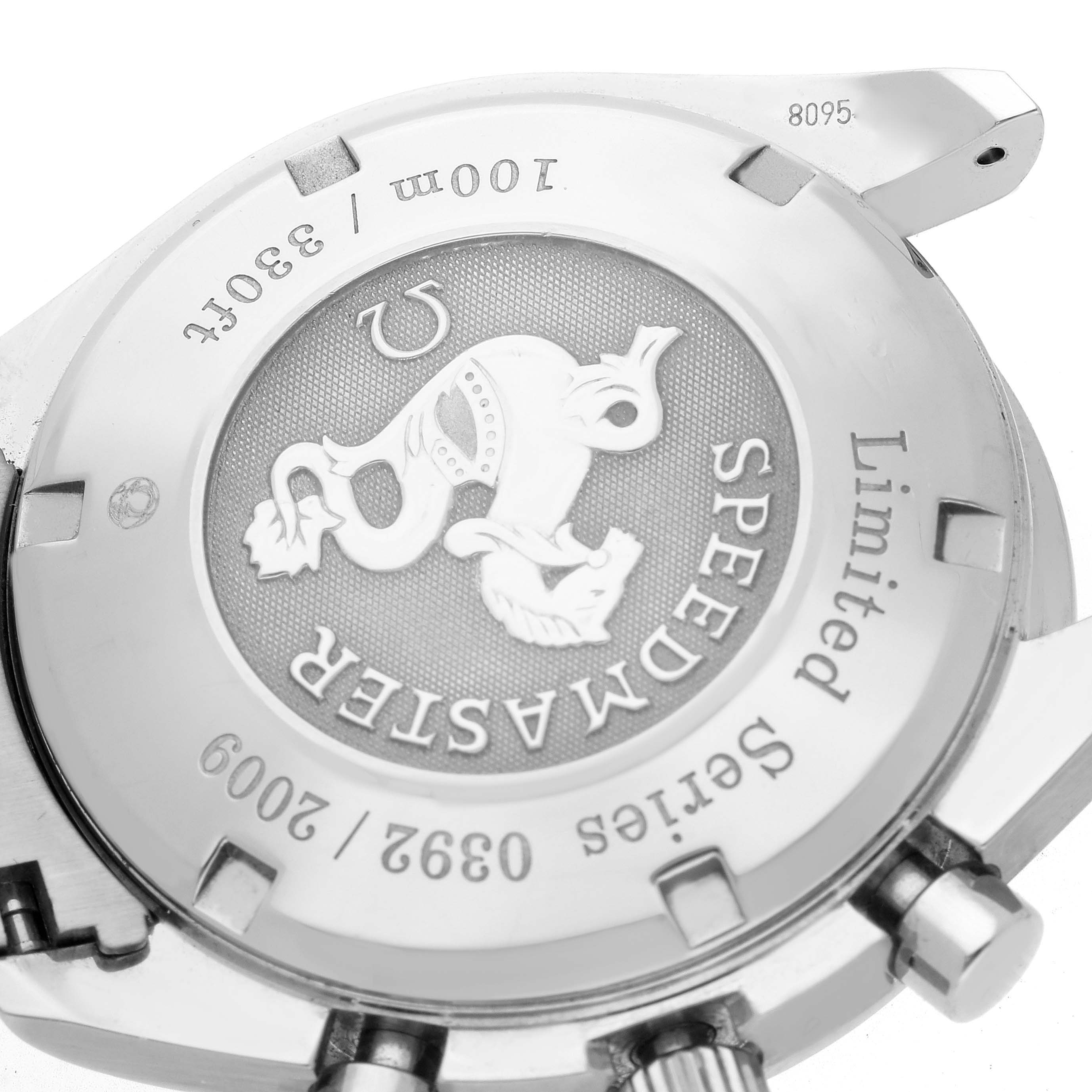 The image shows the case back of an Omega Speedmaster 323.30.40.40.02.001 Men
s Stainless Steel White Dial 323.30.40.40.02.001 Men
s Stainless Steel White Dial watch at an angled view highlighting its engravings and limited series number.