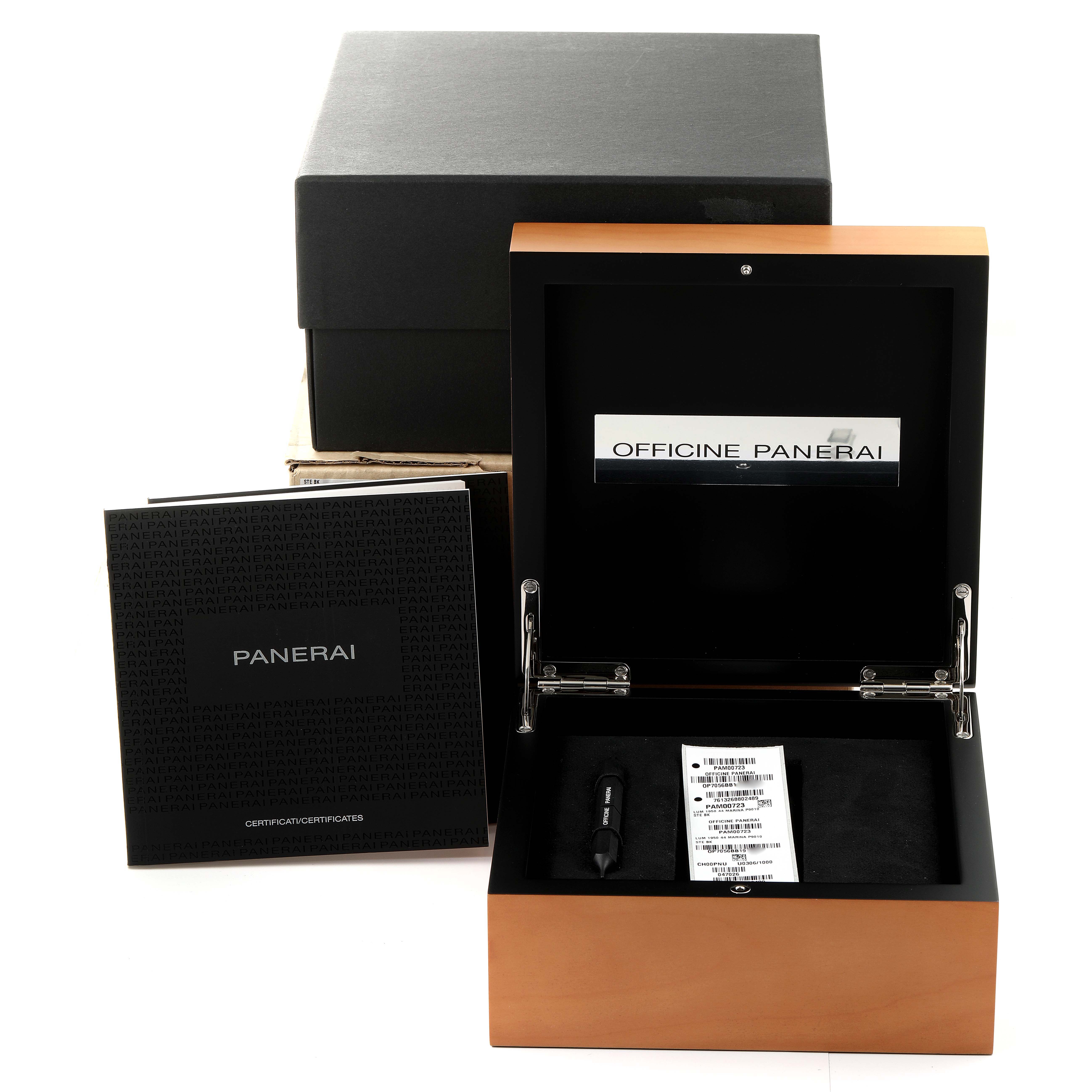 The image shows the open box and packaging for a Luminor model by Panerai, including a tool and documents.