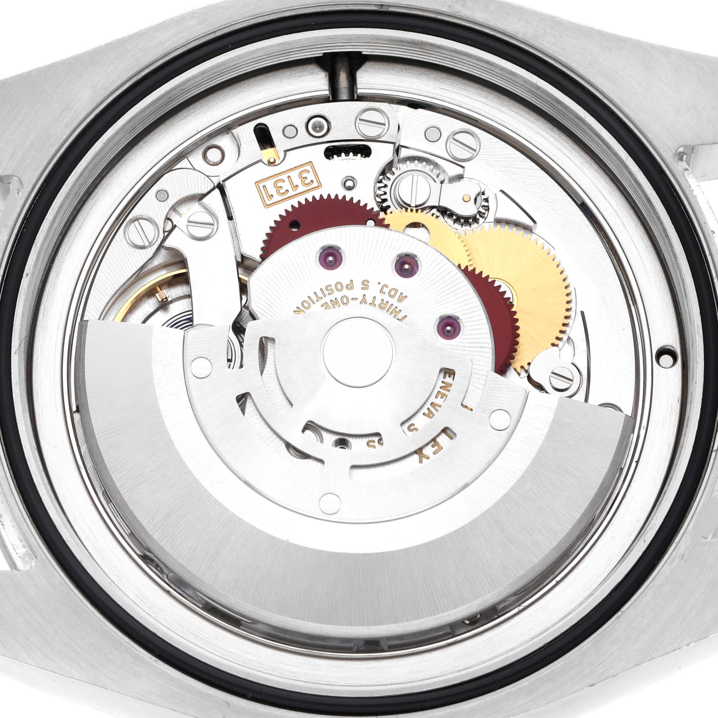 The image shows the movement of a Rolex Air-King 116900 Men's Stainless Steel Black Dial 116900 Men's Stainless Steel Black Dial watch from a top-down angle, revealing gears and the rotor.