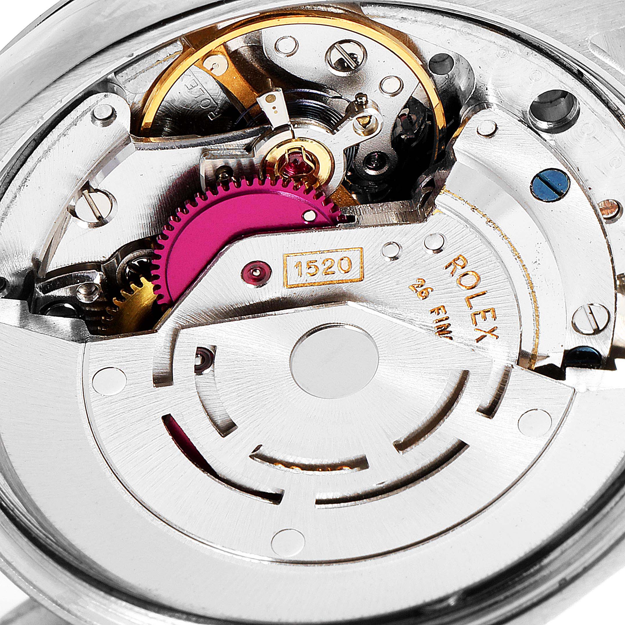 This image shows a close-up of the mechanical movement of a Vintage Collection Rolex watch, highlighting the intricate gears and components.