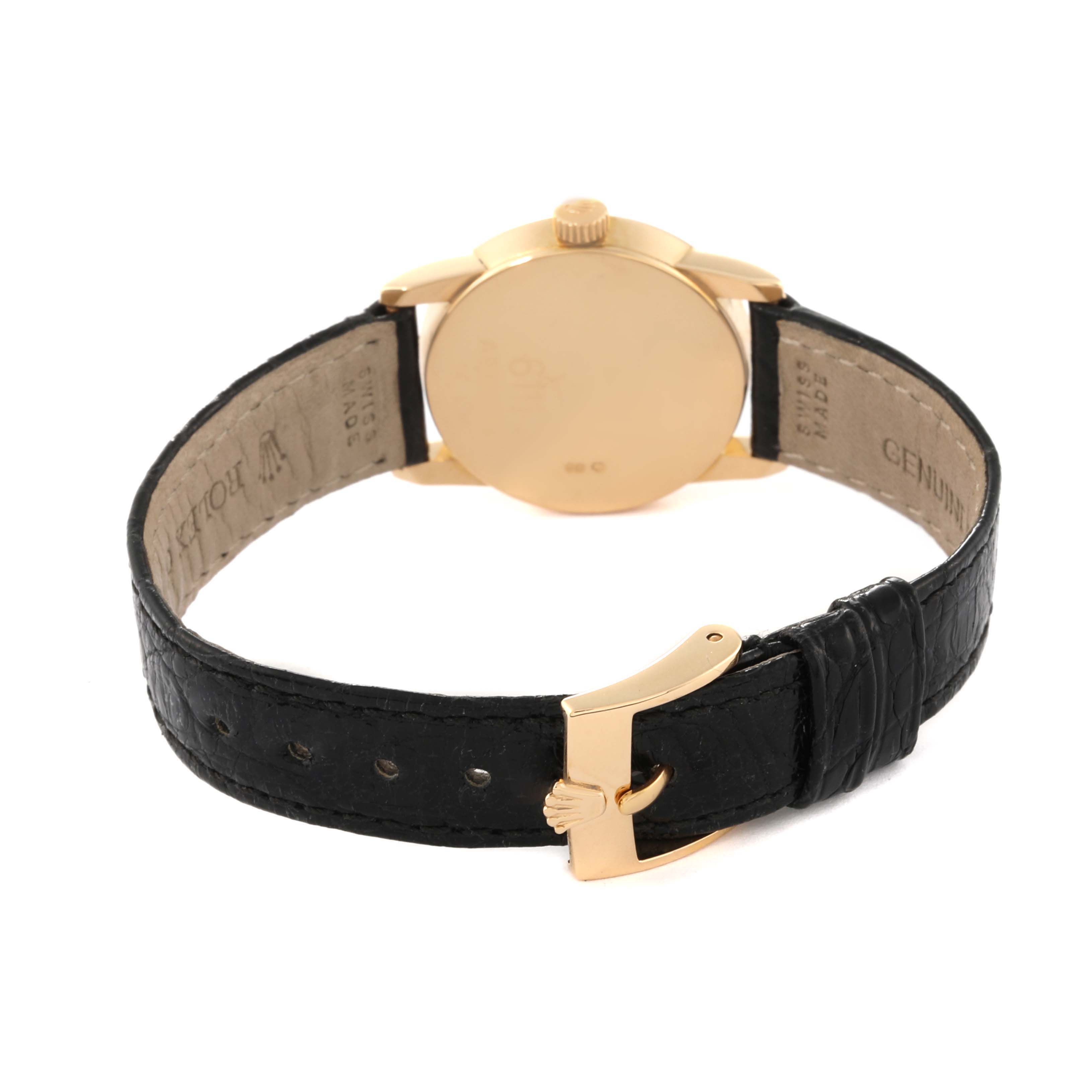 The image shows the back of a Rolex Cellini 6111/8 Women
s Yellow Gold Black Dial 6111/8 Women
s Yellow Gold Black Dial model watch, focusing on its case, crown, and black leather strap with a gold clasp.