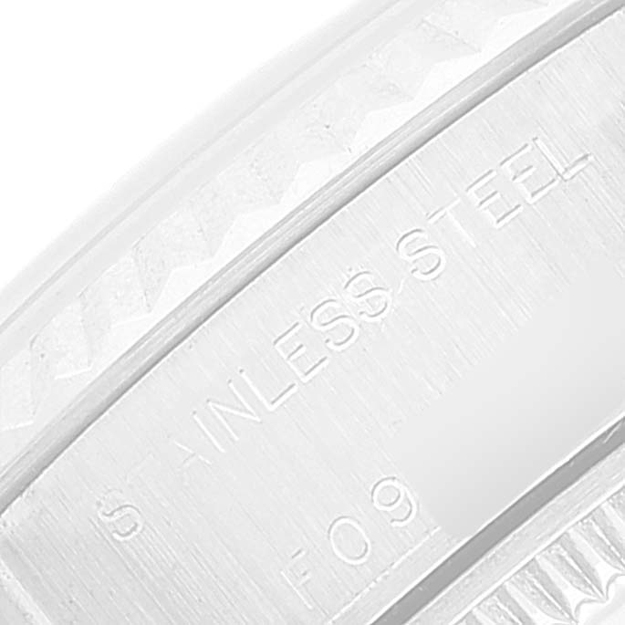 The image shows a close-up of the Rolex Datejust 79174 Women
s Stainless Steel Pink Dial 79174 Women
s Stainless Steel Pink Dial watch, focusing on the engraved stainless steel part.