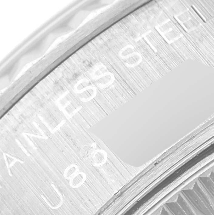 The image shows a close-up of the edge of a Rolex Datejust 69174 Women
s Stainless Steel Black Dial 69174 Women
s Stainless Steel Black Dial watch, focusing on part of the bezel and the "STAINLESS STEEL" engraving.