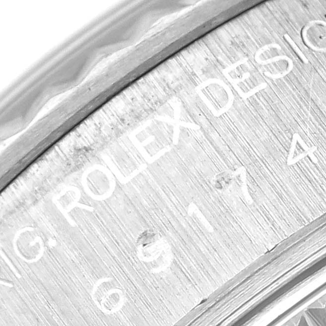 The image shows a close-up view of the engraved bezel area of the Rolex Datejust 69174 Women
s Stainless Steel Black Dial 69174 Women
s Stainless Steel Black Dial watch.