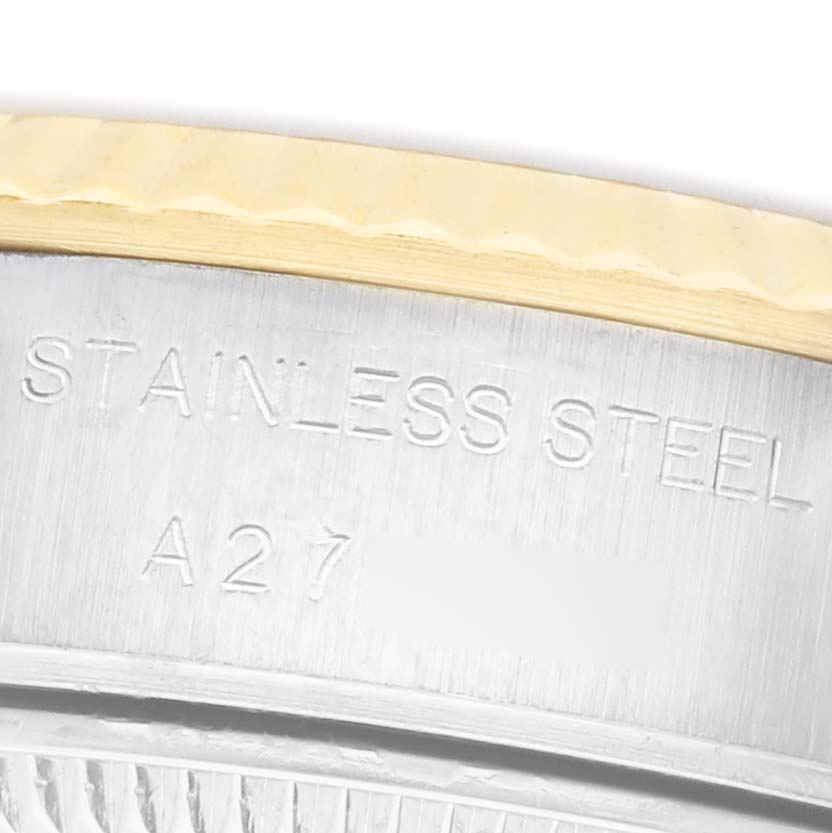 The image shows a close-up of the side of a Rolex Datejust 79173 Women's Steel and Gold (two tone) Champagne Dial watch, focusing on the stainless steel engraving.