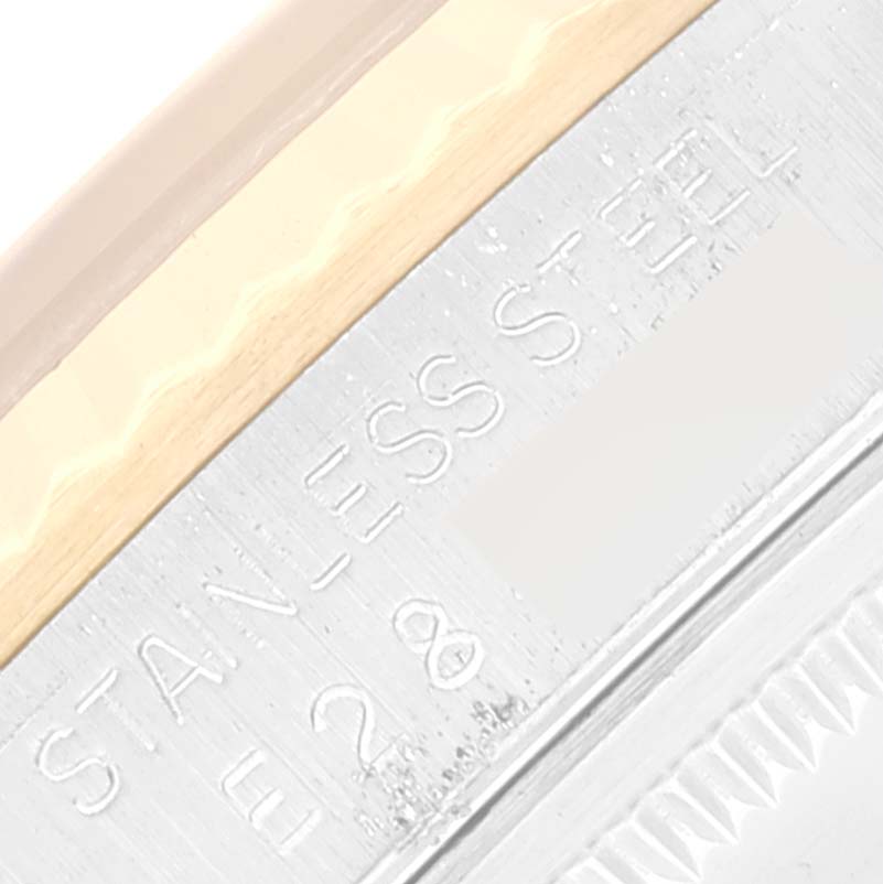 The image shows a close-up of the engraved side of the Rolex Datejust 16233 Men
s Steel and Gold (two tone) Champagne Dial 16233 Men
s Steel and Gold (two tone) Champagne Dial watch case, highlighting material details.