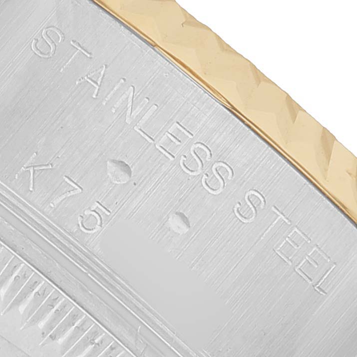 The image shows a close-up of the Rolex Datejust 79173 Women's Steel and Gold (two tone) White Dial watch, highlighting the edge of the bezel with "STAINLESS STEEL" engraving.