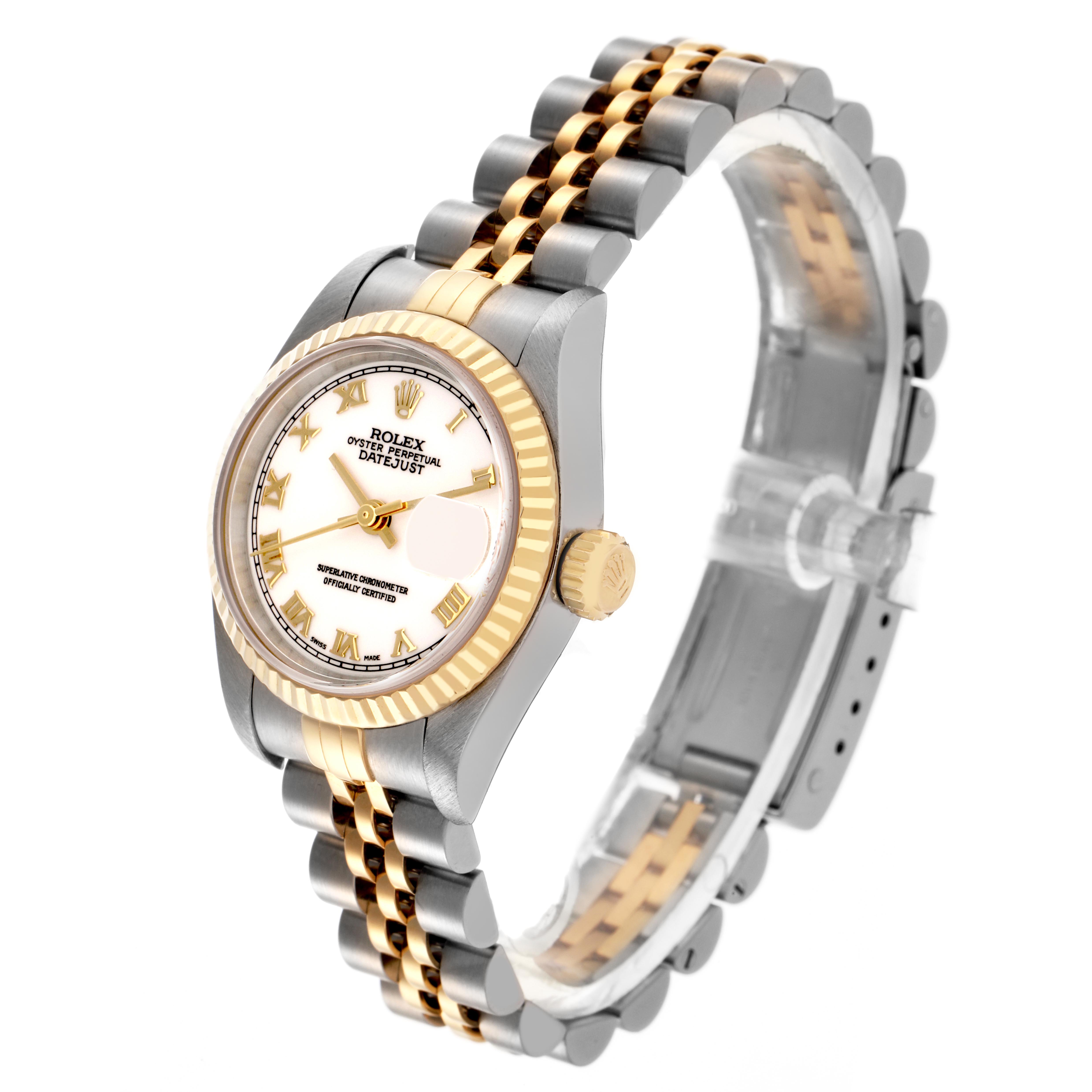 The image shows a Rolex Datejust 79173 Women
s Steel and Gold (two tone) White Dial 79173 Women
s Steel and Gold (two tone) White Dial watch at a three-quarter angle, highlighting its face, bezel, crown, and two-tone bracelet.