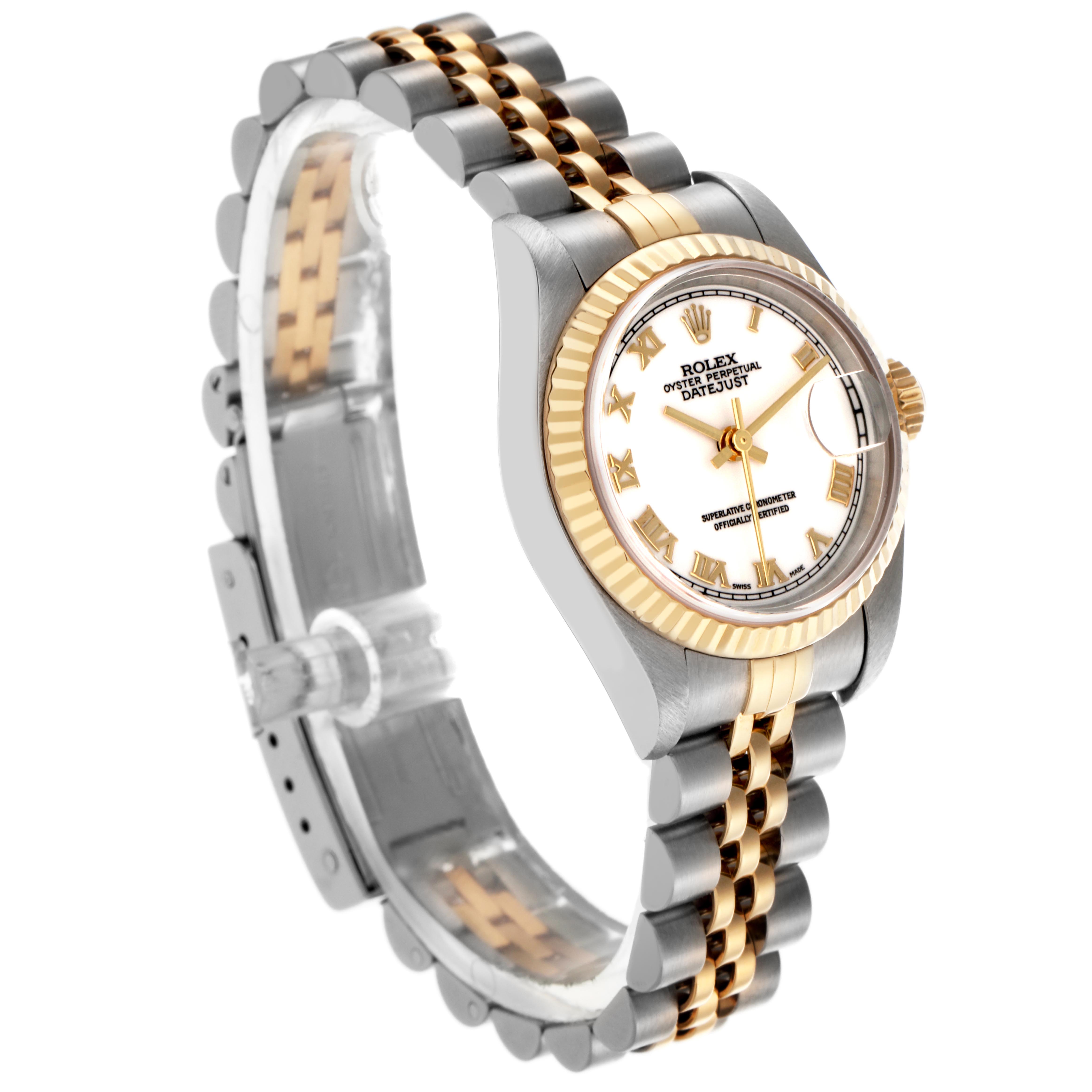 The Rolex Datejust 79173 Women
s Steel and Gold (two tone) White Dial 79173 Women
s Steel and Gold (two tone) White Dial watch is shown at a slight angle, revealing the bezel, bracelet, and dial with Roman numerals.