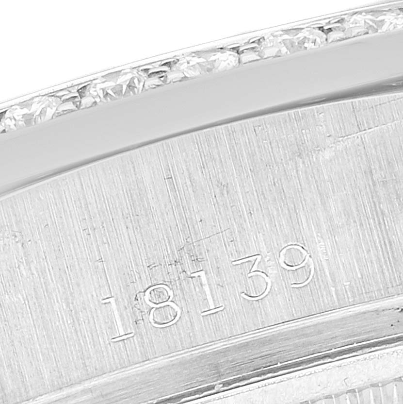 The close-up image shows the edge of a Rolex President 18139 Men
s White Gold Brown Dial 18139 Men
s White Gold Brown Dial model watch, highlighting the serial number and a diamond-studded bezel.