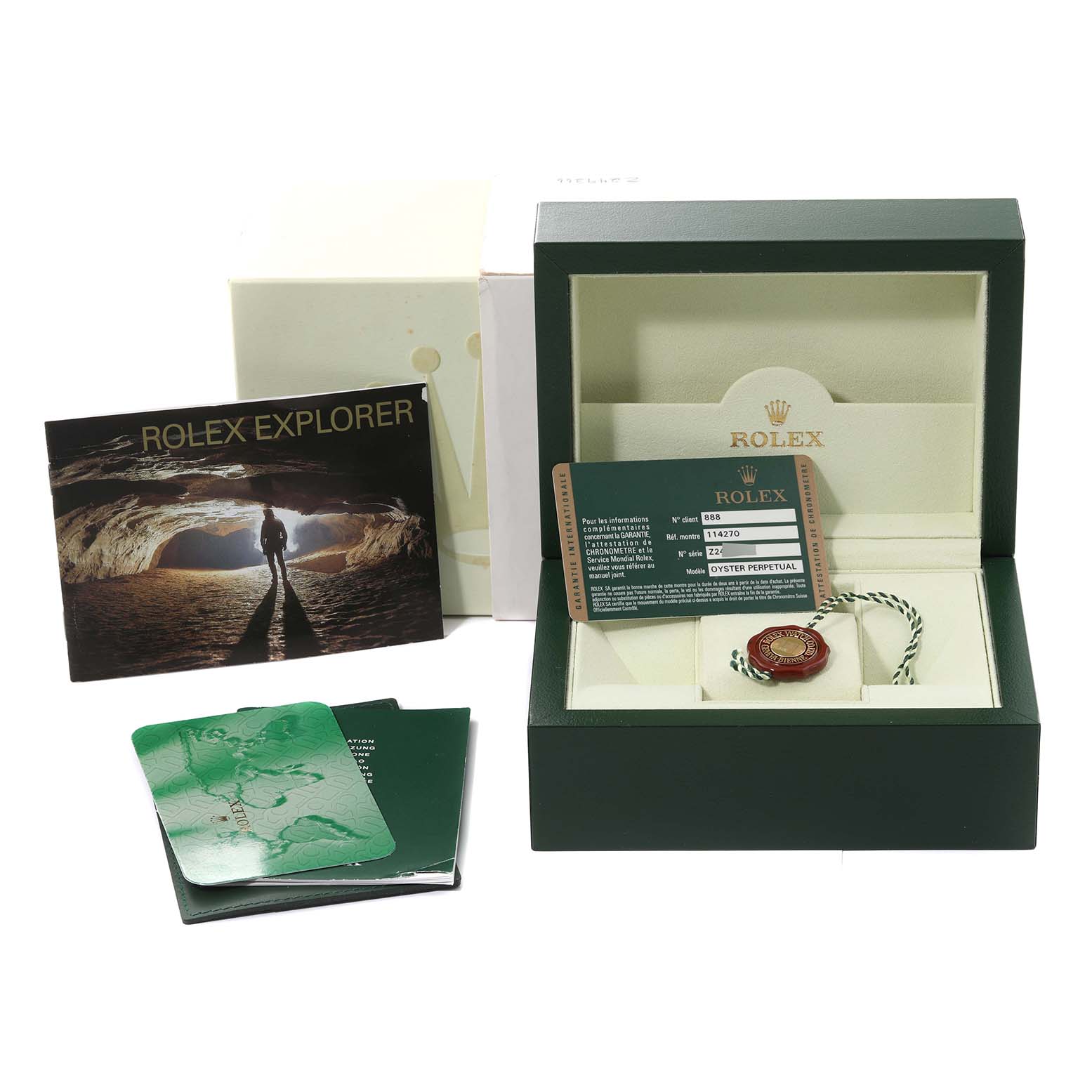 The image shows the packaging, tags, a booklet, and warranty card for the Rolex Explorer 114270 Men
s Stainless Steel Black Dial 114270 Men
s Stainless Steel Black Dial watch.