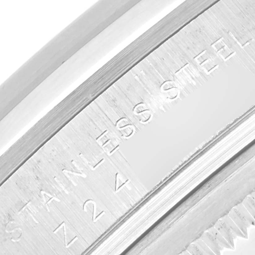 This close-up image shows part of the stainless steel edge with engraved text on a Rolex Explorer 114270 Men
s Stainless Steel Black Dial 114270 Men
s Stainless Steel Black Dial watch.