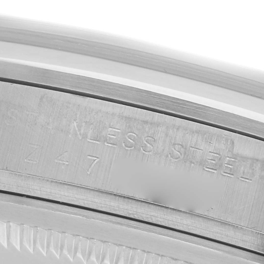 The image shows a close-up of the case back engraving on the Rolex Explorer 114270 Men
s Stainless Steel Black Dial 114270 Men
s Stainless Steel Black Dial, depicting "STAINLESS STEEL" and part of the serial number.