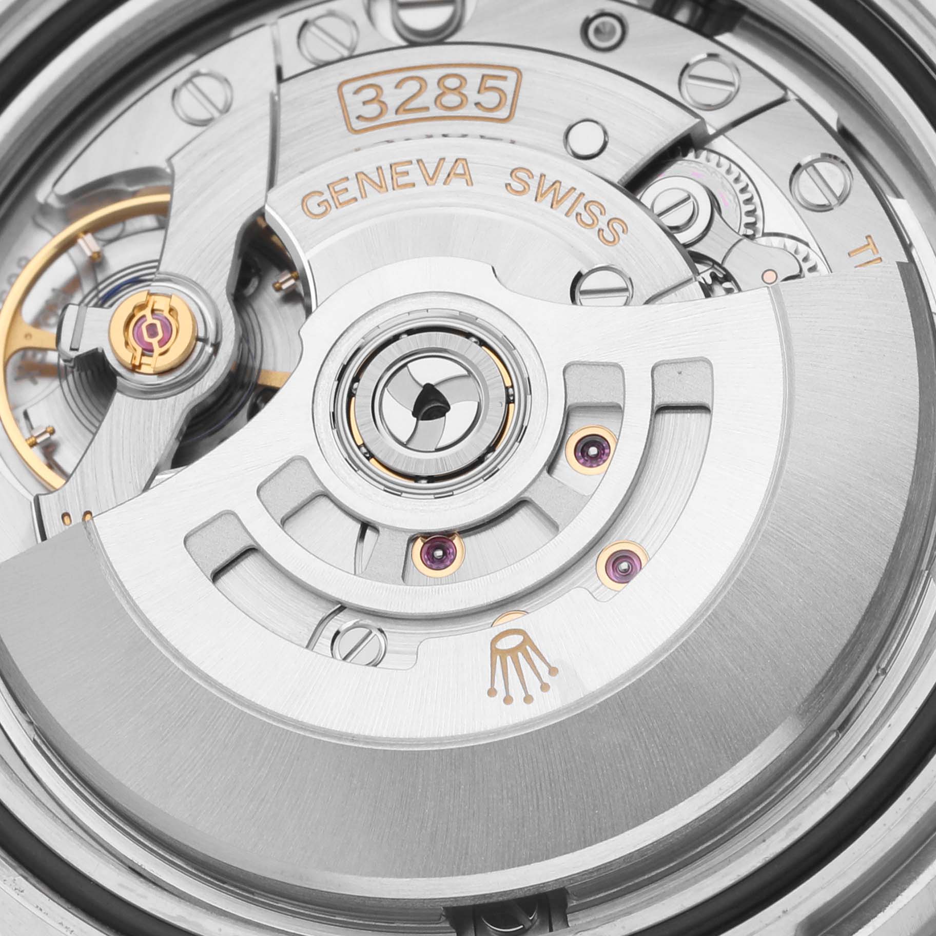 The image shows a close-up of the movement inside a Rolex GMT-Master 126710BLNR Men
s Stainless Steel Black Dial 126710BLNR Men
s Stainless Steel Black Dial, focusing on the automatic rotor and internal mechanics.