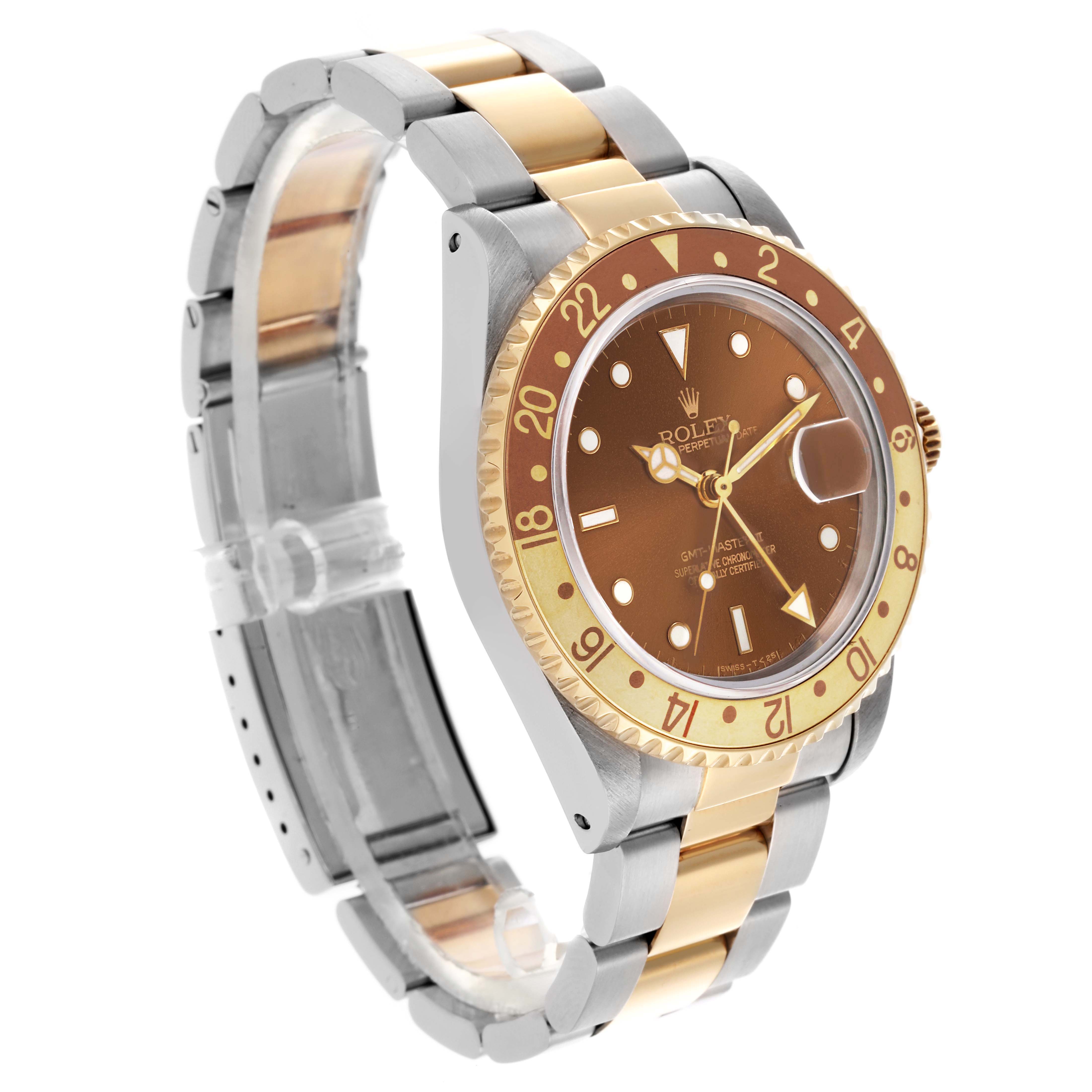 The Rolex GMT-Master 16713 Men
s Steel and Gold (two tone) Brown Dial 16713 Men
s Steel and Gold (two tone) Brown Dial is shown at a three-quarter angle, highlighting its brown dial, bezel, and two-tone bracelet.