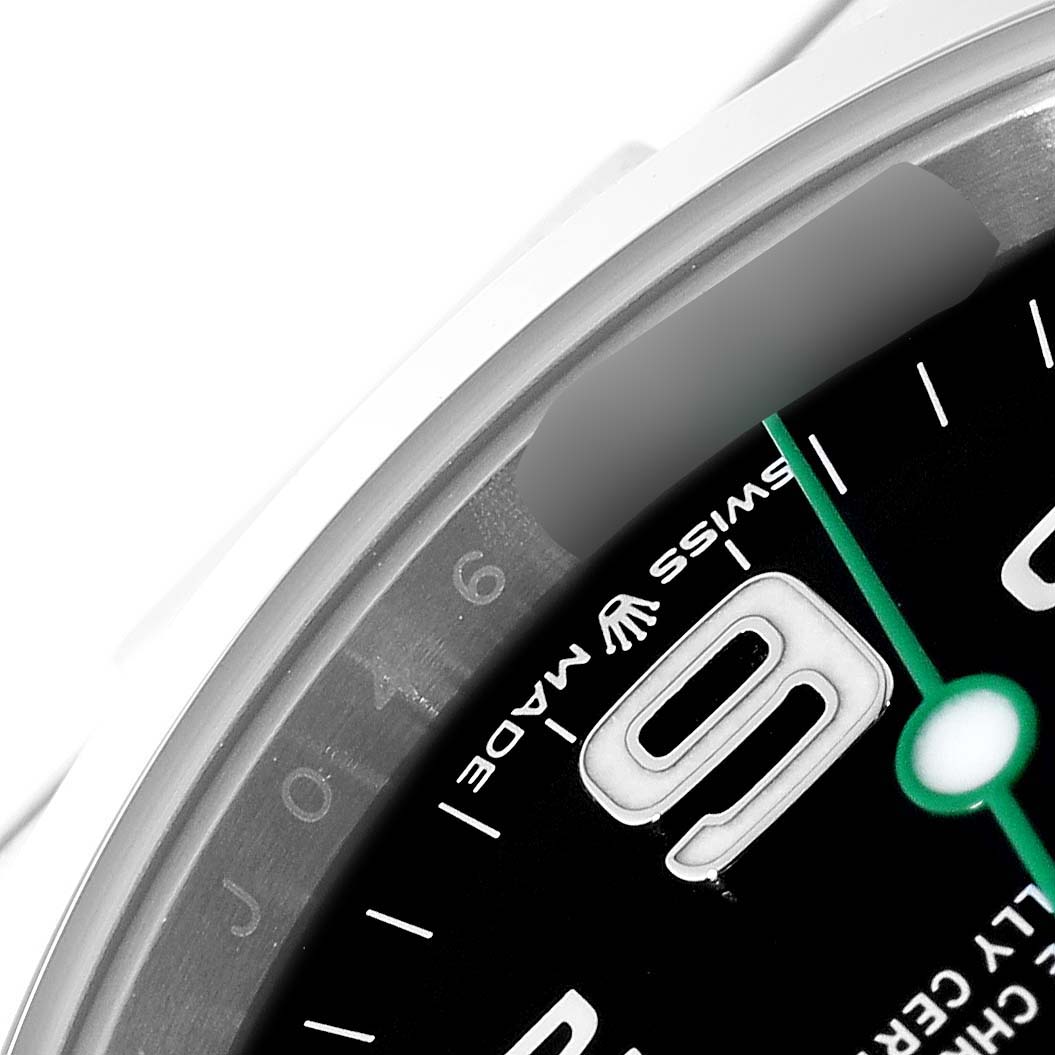This image shows a close-up of the dial and bezel of a Rolex Air-King 126900 Men's Stainless Steel Black Dial 126900 Men's Stainless Steel Black Dial watch, highlighting the 9 o'clock position and part of the "Swiss Made" label.