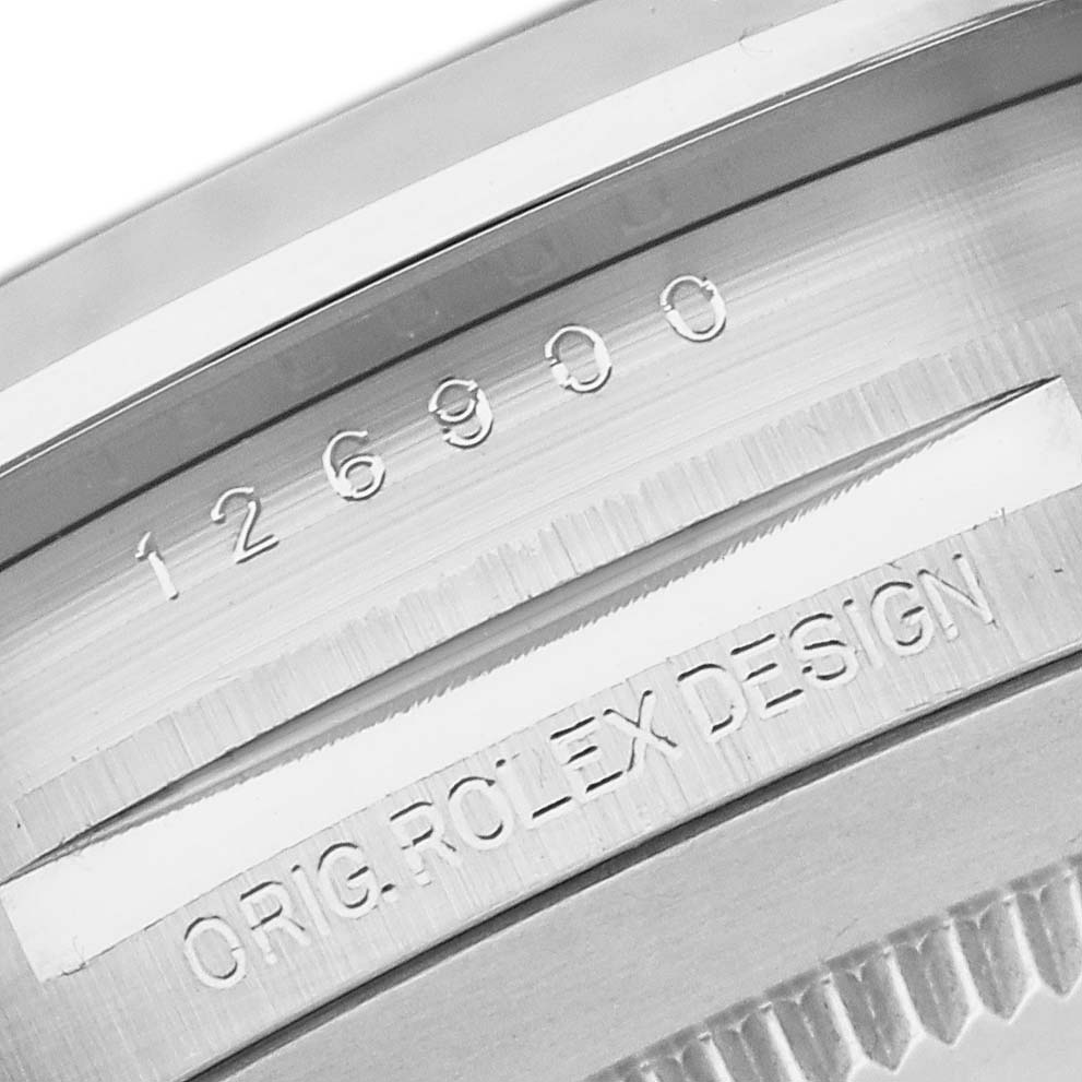 This close-up image shows the engraved serial number and "ORIG ROLEX DESIGN" on the casing of the Rolex Air-King 126900 Men's Stainless Steel Black Dial 126900 Men's Stainless Steel Black Dial watch.