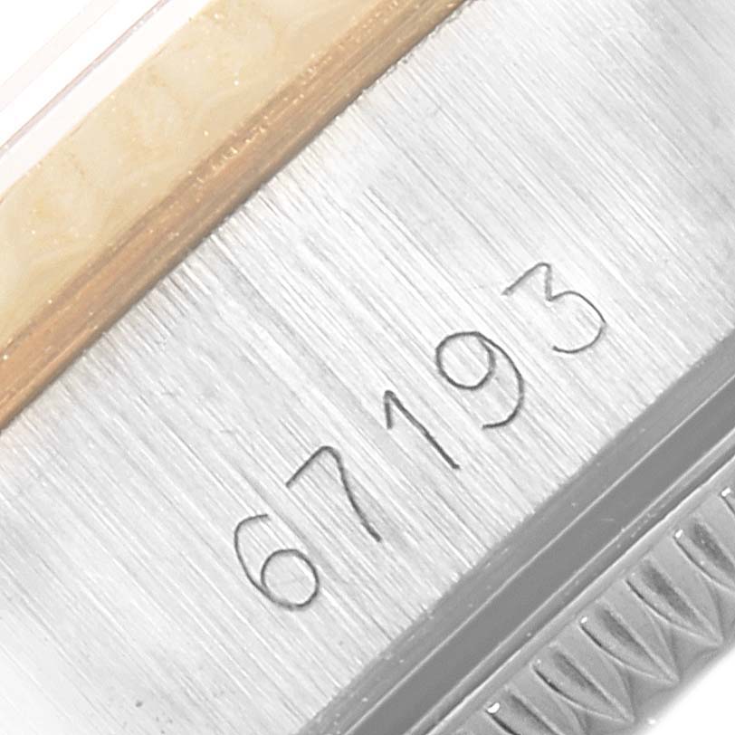 This image shows a close-up of the side of a Rolex Oyster Perpetual 67193 Women
s Steel and Gold (two tone) Champagne Dial 67193 Women
s Steel and Gold (two tone) Champagne Dial watch case, featuring the model number 67193.