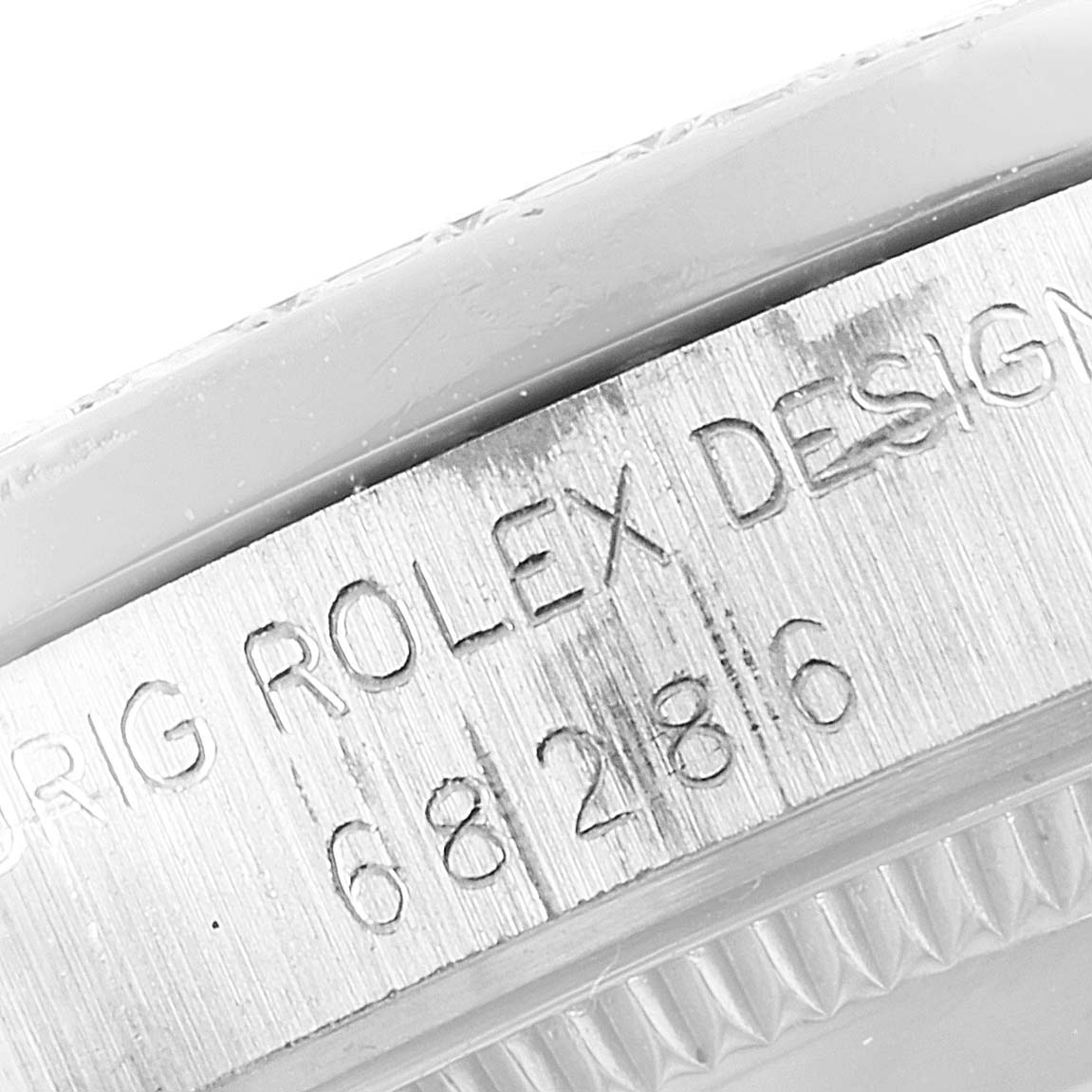The image shows the side of the case of a Rolex President 68286 Women's White Gold Silver Dial 68286 Women's White Gold Silver Dial model, featuring engraved text and serial numbers.