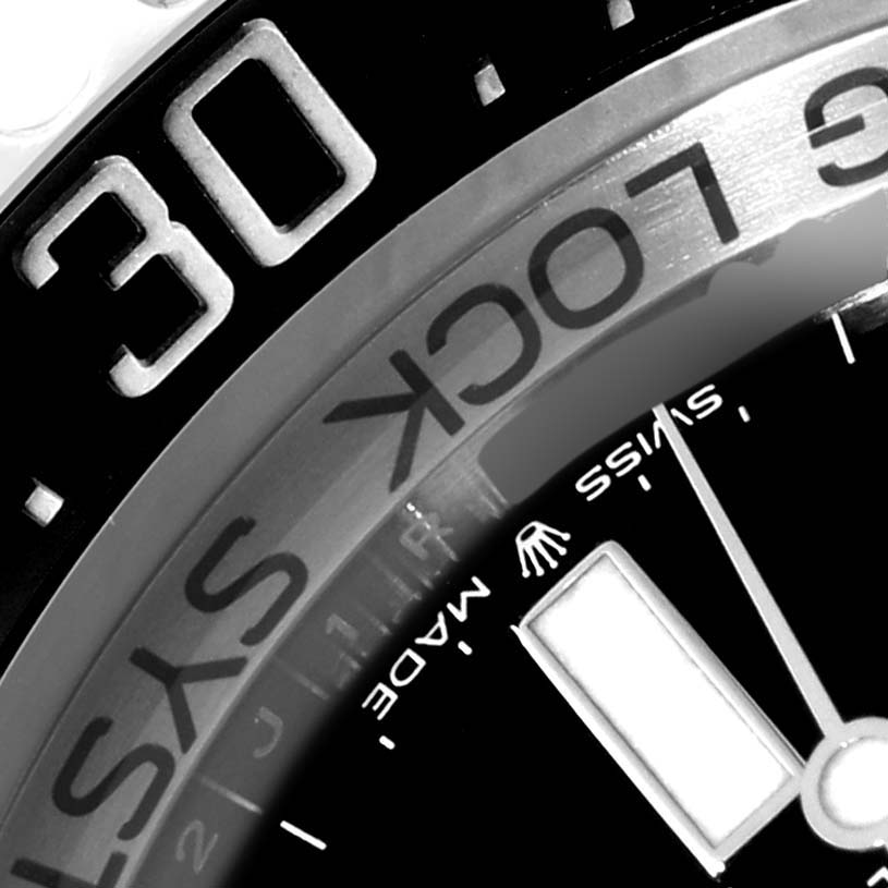 This close-up image of a Rolex Sea-Dweller 126660 Men
s Stainless Steel Black Dial 126660 Men
s Stainless Steel Black Dial watch shows part of the bezel and dial, including the "30" marker and some text.