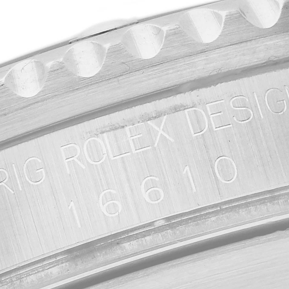 This image shows a close-up of the bezel and the engraved inner case of a Rolex Submariner 16610 Men
s Stainless Steel Black Dial 16610 Men
s Stainless Steel Black Dial watch, model number 16610.