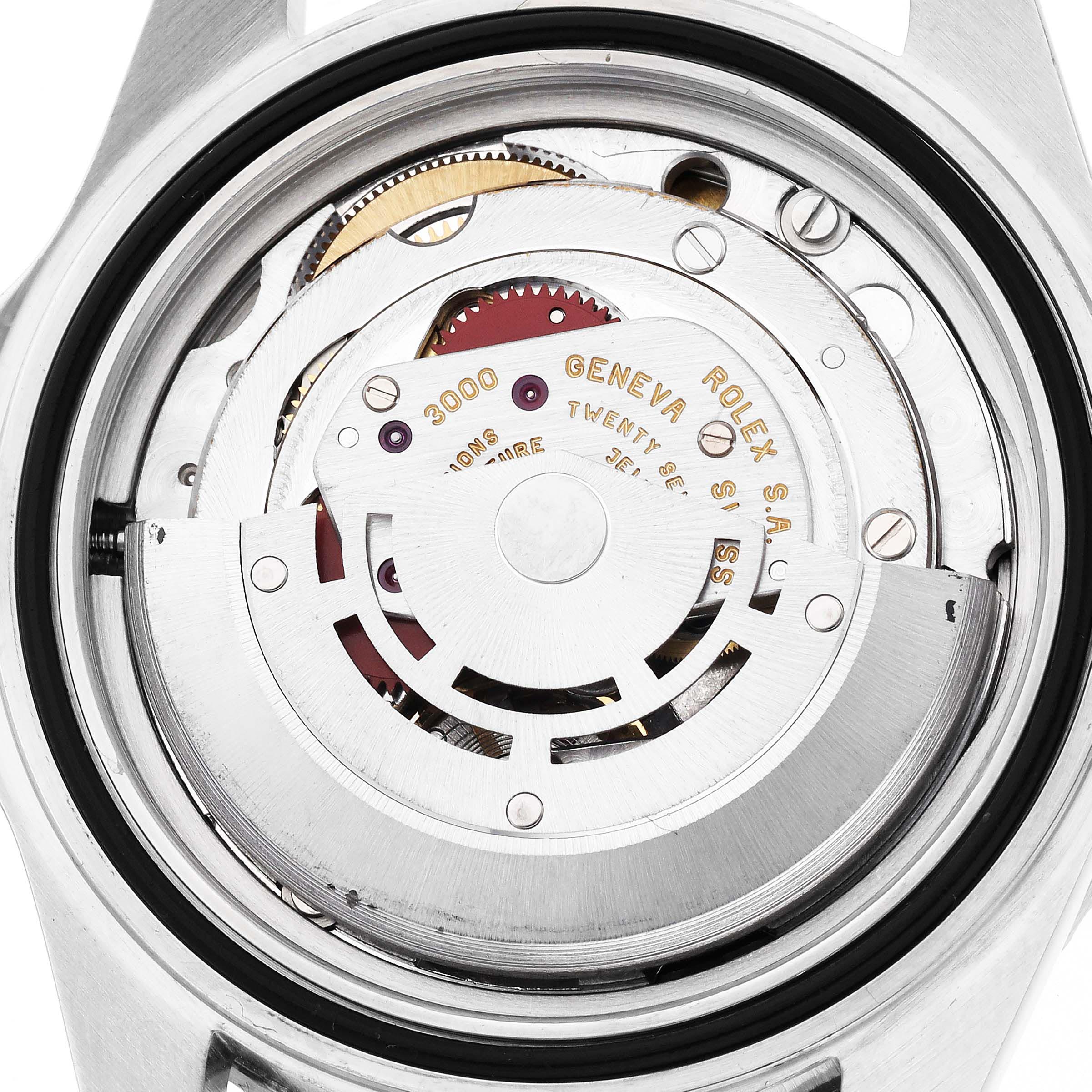 The image shows the internal movement of a Rolex Submariner 14060 Men
s Stainless Steel Black Dial 14060 Men
s Stainless Steel Black Dial watch from the back, highlighting gears and inscriptions.