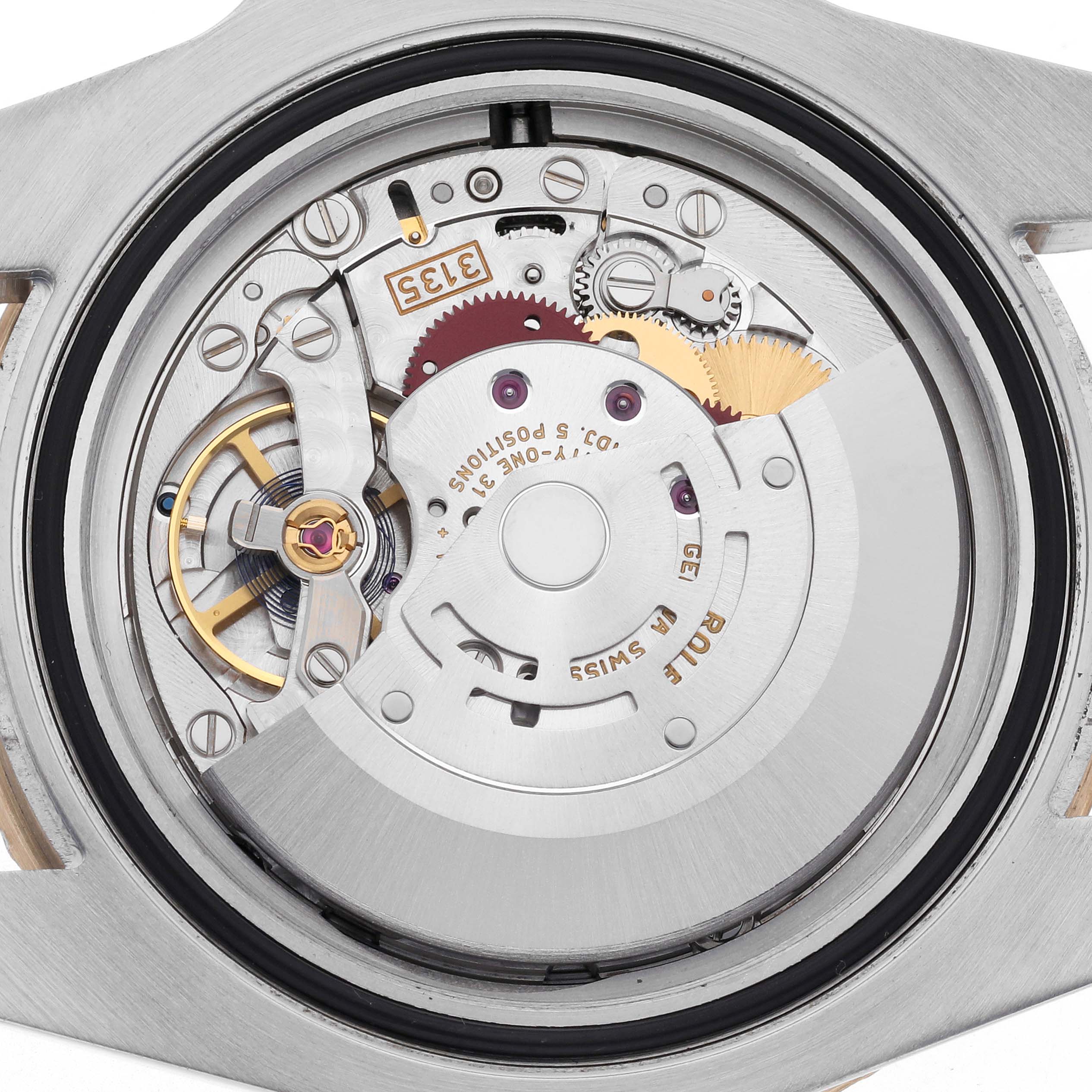 The image shows the internal mechanism of a Rolex Submariner 116613 Men
s Steel and Gold (two tone) Black Dial 116613 Men
s Steel and Gold (two tone) Black Dial watch from a top-down angle, highlighting the movement components.