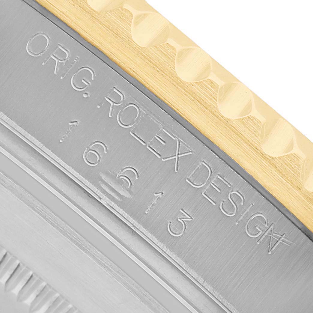 The image shows a close-up of the Rolex Submariner 16613 Men's Steel and Gold (two tone) Black Dial's case side, displaying its engraved details.