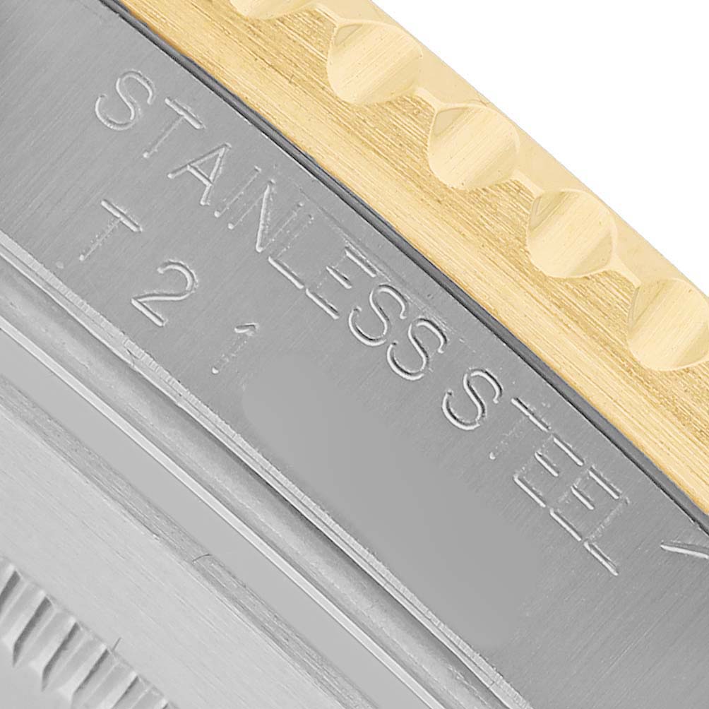 The image shows a close-up of a Rolex Submariner 16613 Men's Steel and Gold (two tone) Black Dial watch, focusing on the stainless steel and gold-edged bezel with engraved text.