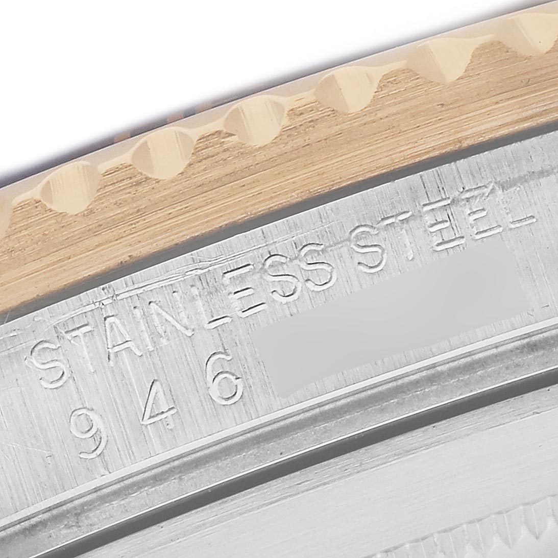 The image shows a close-up of the bezel and case edge with inscriptions on a Rolex Submariner 16803 Men
s Steel and Gold (two tone) Black Dial 16803 Men
s Steel and Gold (two tone) Black Dial watch.