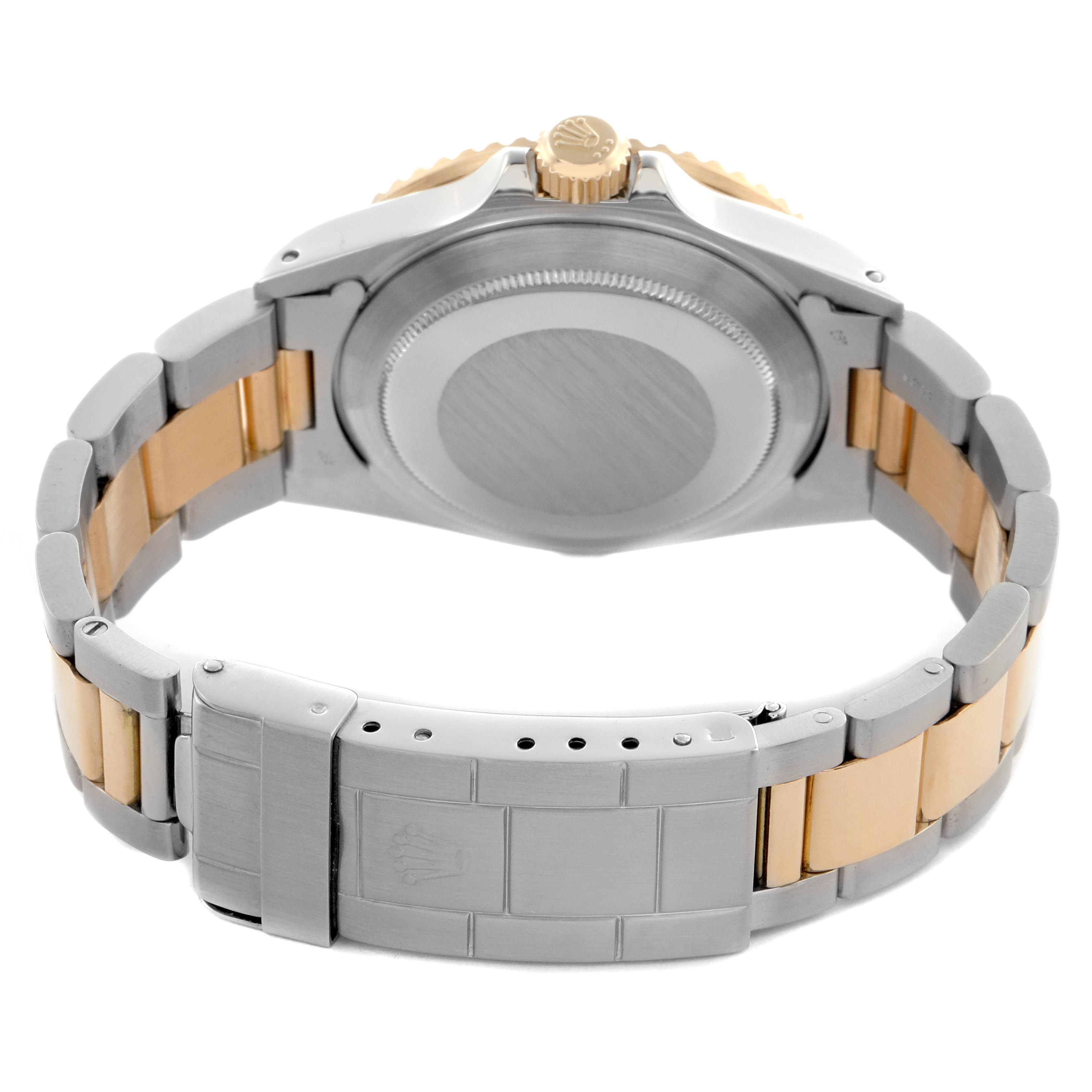 The Rolex Submariner 16803 Men
s Steel and Gold (two tone) Black Dial 16803 Men
s Steel and Gold (two tone) Black Dial watch is shown from the back, highlighting the case back, crown, and two-tone bracelet.