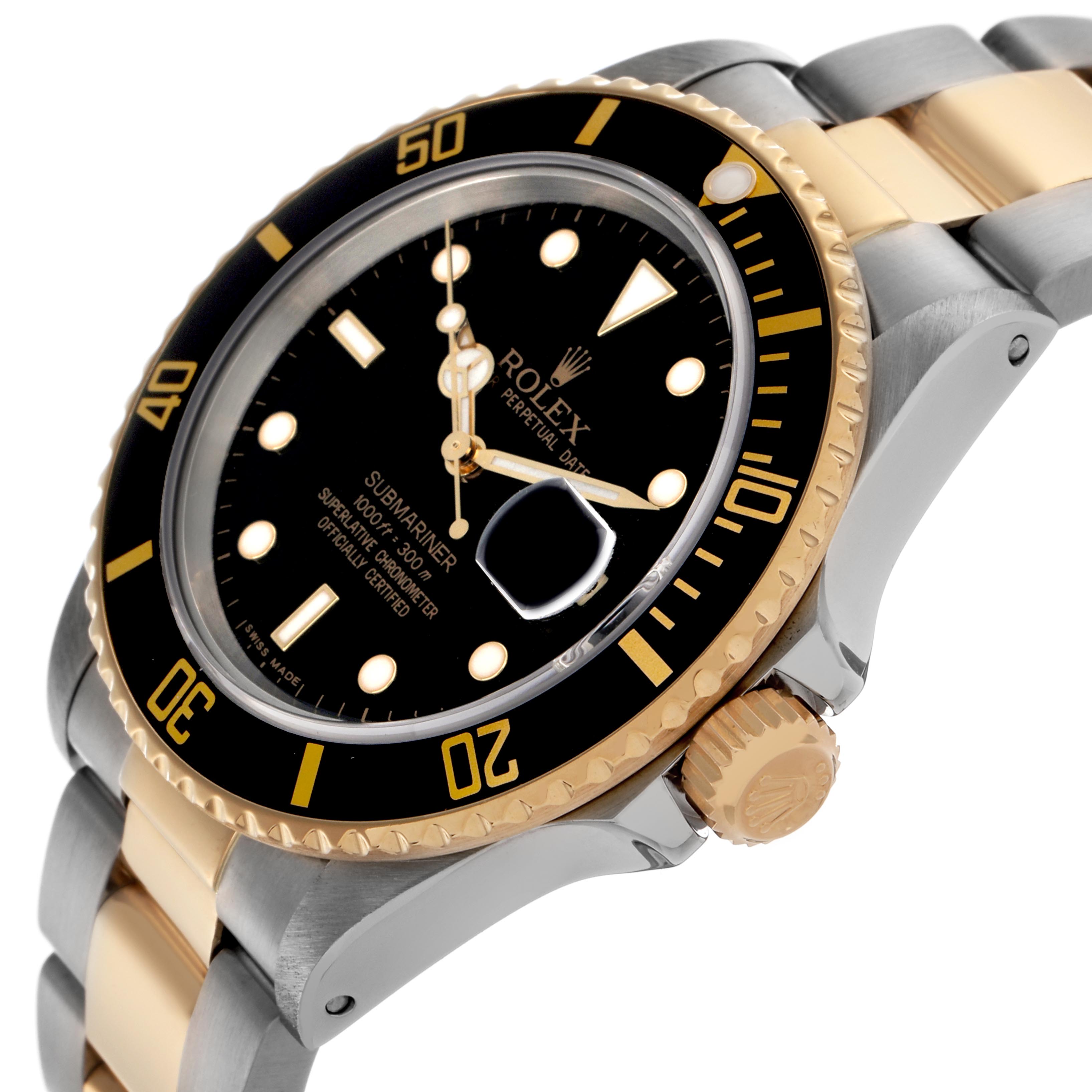 The Rolex Submariner 16803 Men
s Steel and Gold (two tone) Black Dial 16803 Men
s Steel and Gold (two tone) Black Dial watch is shown at an angled side view, featuring the bezel, dial, crown, and part of the bracelet.