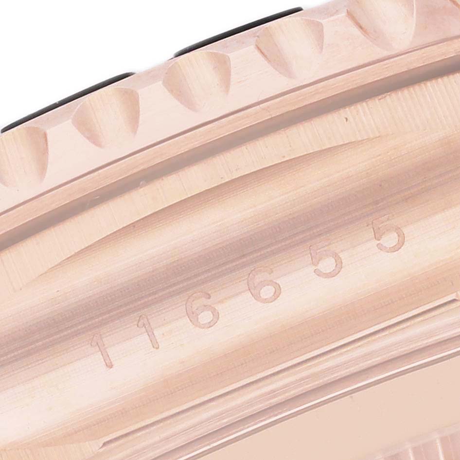 This close-up image of a Rolex Yacht-Master 116655 Men's Rose Gold Silver Dial 116655 Men's Rose Gold Silver Dial watch shows the engraved case number and a portion of the bezel.