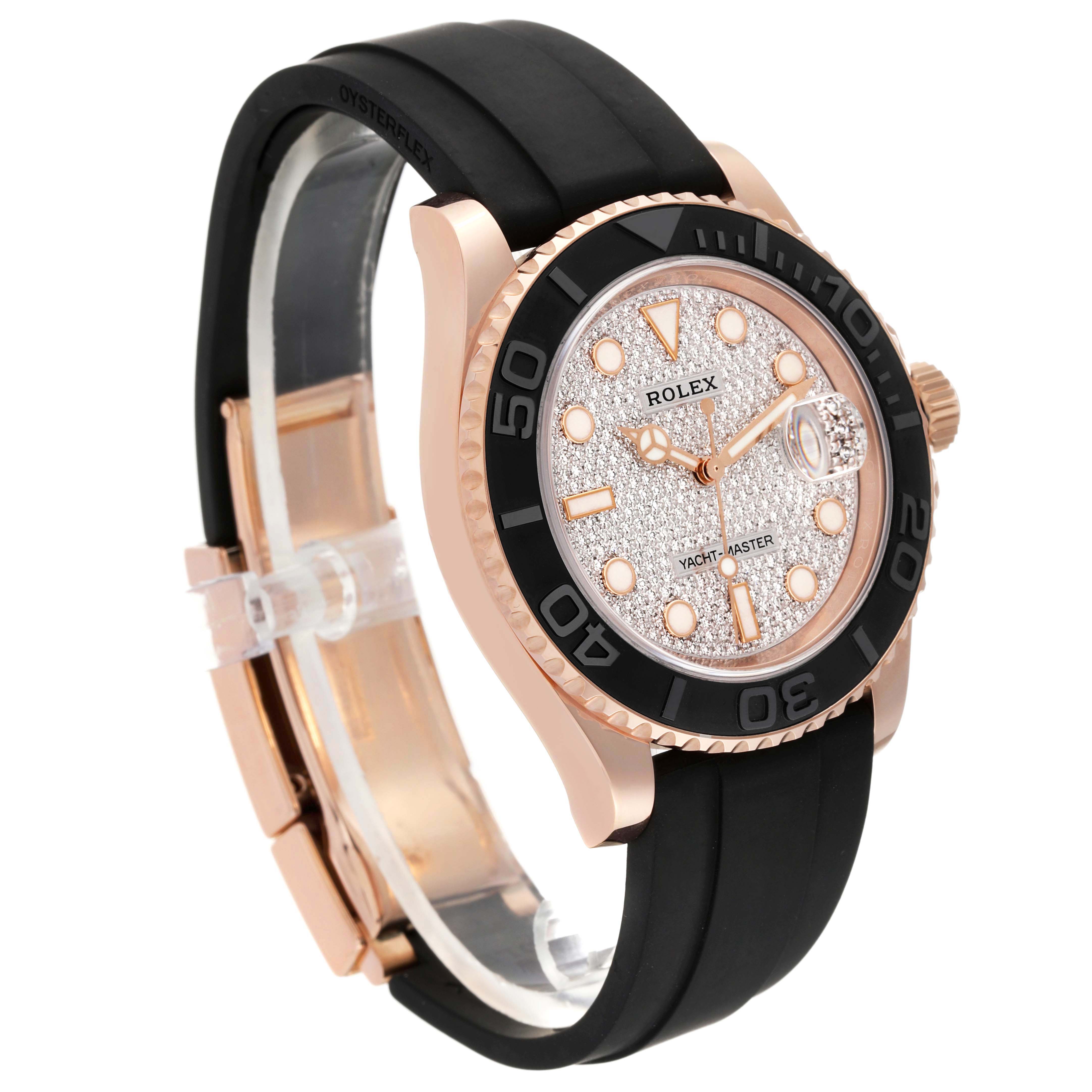 The Rolex Yacht-Master 116655 Men's Rose Gold Silver Dial is shown at a three-quarter angle, displaying the dial, bezel, case, and black strap.