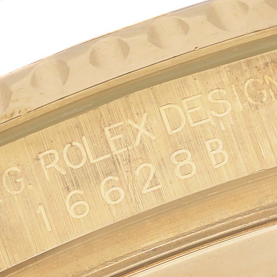 The image shows a close-up of the gold bezel with engraved text of a Rolex Yacht-Master 16628B Men
s Yellow Gold Mother of Pearl Dial 16628B Men
s Yellow Gold Mother of Pearl Dial watch.