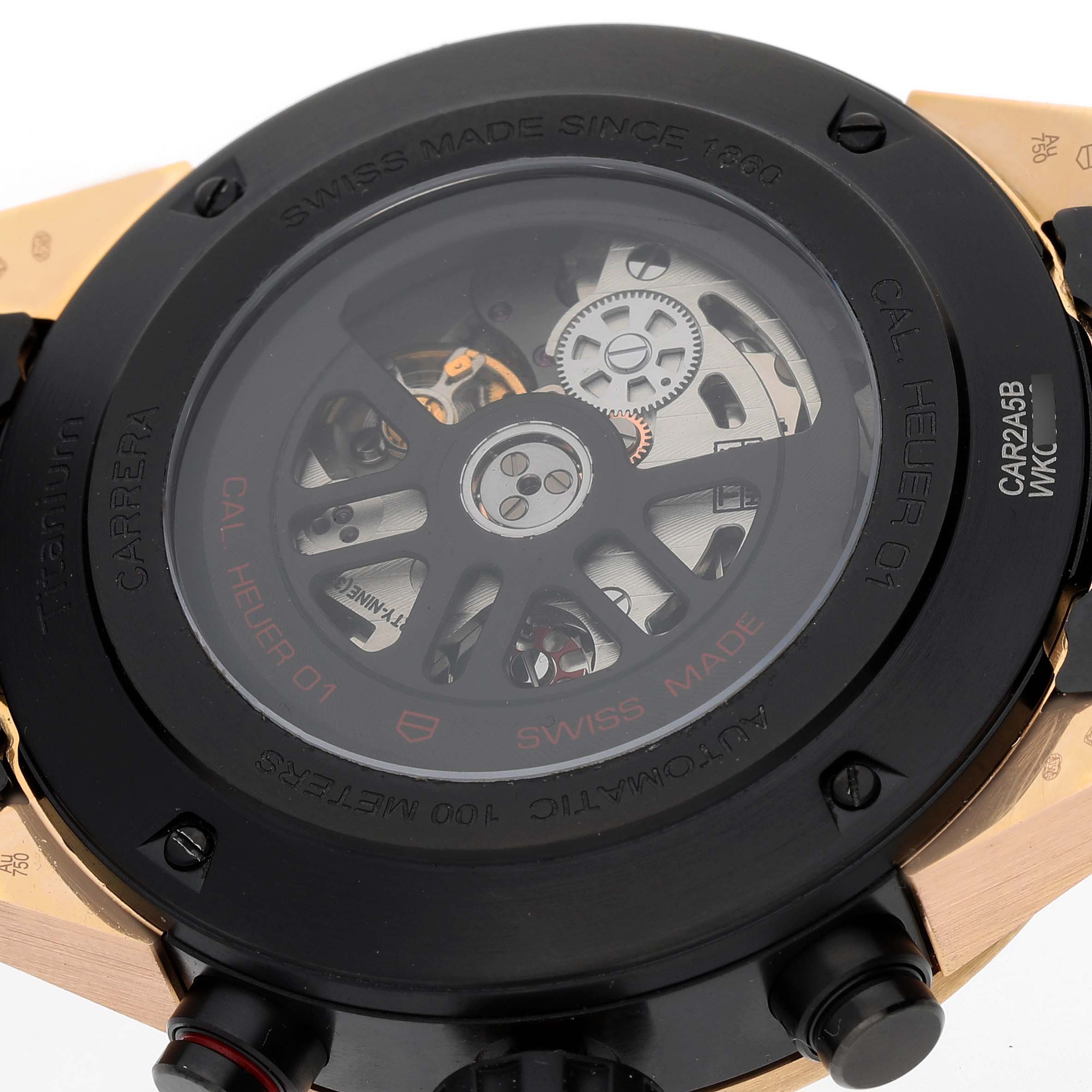 The image shows the back of a Tag Heuer Carrera CAR2A5B.FT6044 Men's Rose Gold Black Dial watch, highlighting its automatic movement and internal mechanisms.