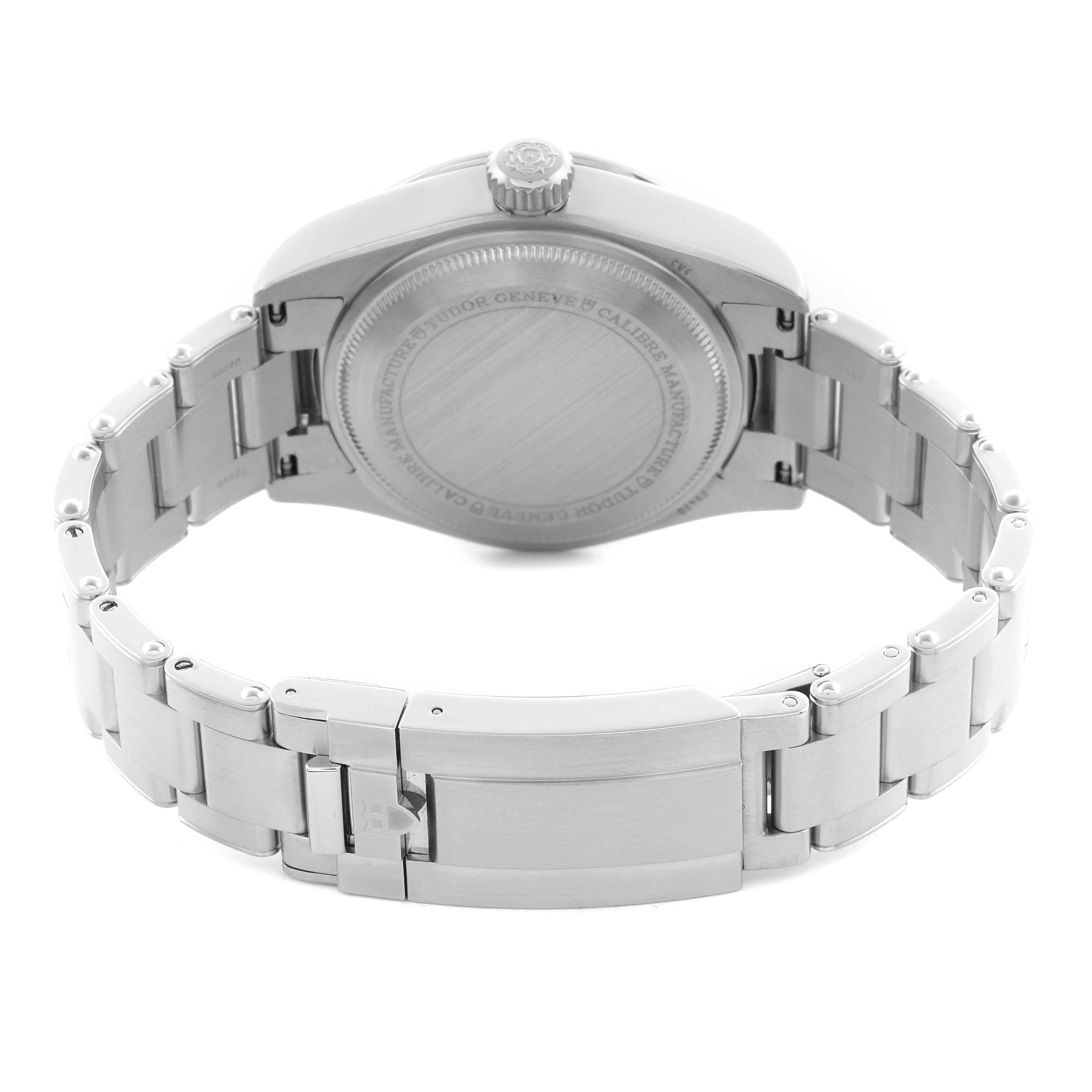 The image shows the back view of a Tudor Heritage Black Bay 79470 Men
s Stainless Steel Black Dial 79470 Men
s Stainless Steel Black Dial watch, highlighting the case back, crown, and metal bracelet clasp.