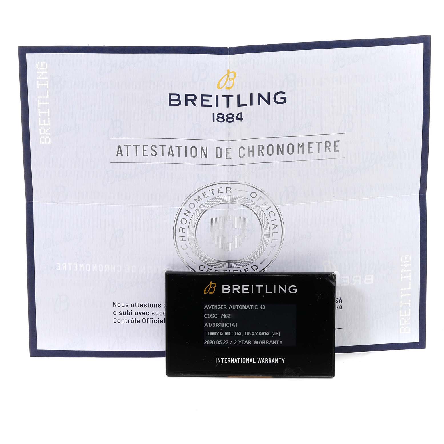 The image shows a warranty card and a chronometer certification booklet for the Breitling Avenger A17318 Men's Stainless Steel Blue Dial A17318 Men's Stainless Steel Blue Dial model.