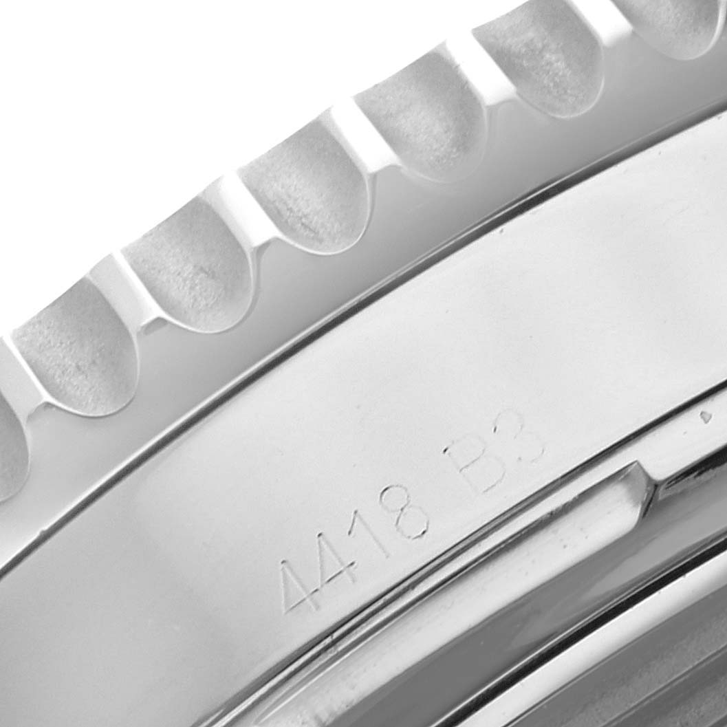 The image shows a close-up of the bezel and part of the casing of a Breitling Navitimer AB0121 Men's Stainless Steel Black Dial AB0121 Men's Stainless Steel Black Dial watch.