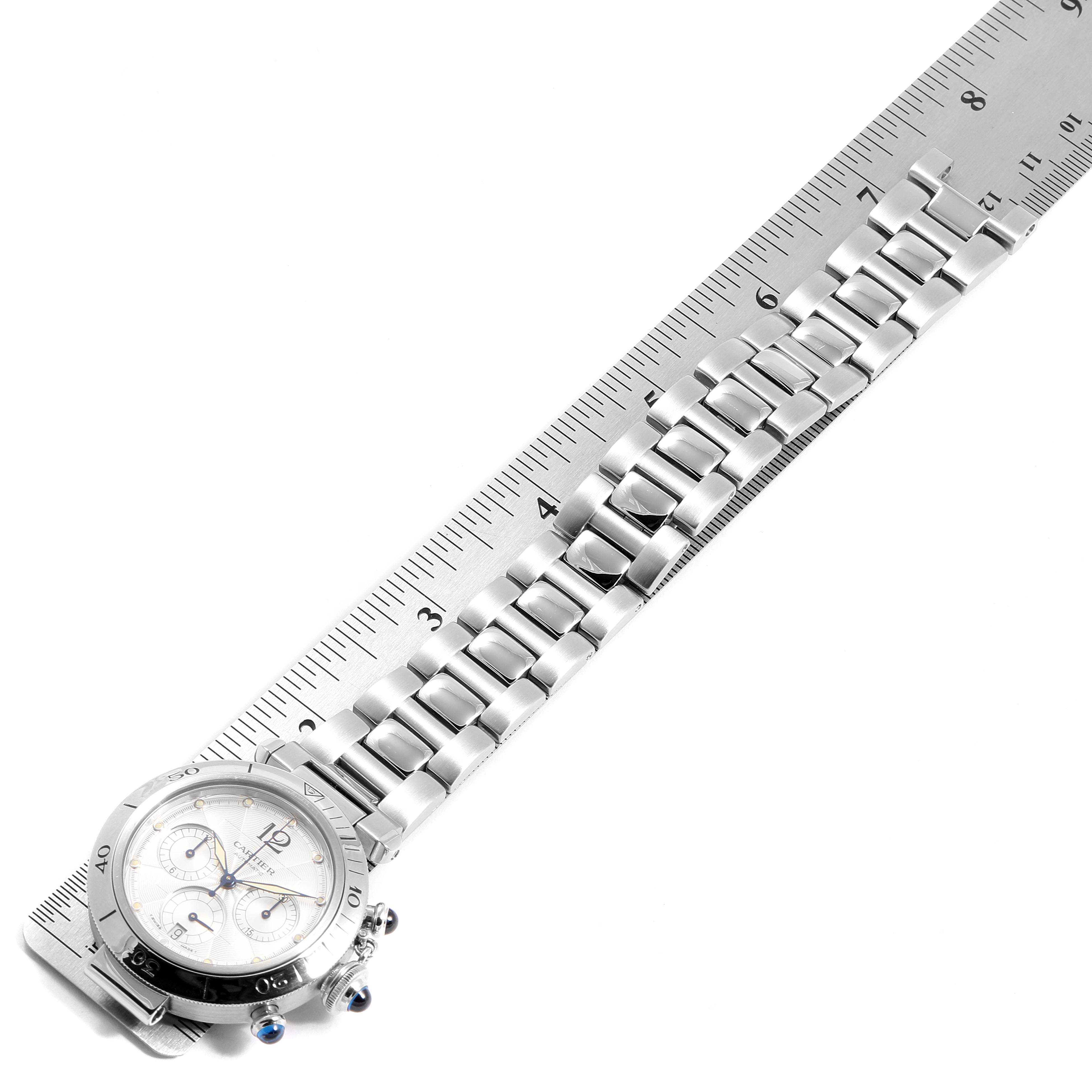 The image shows a side angle of the Cartier Pasha W31030H3 Men's Stainless Steel Silver Dial W31030H3 Men's Stainless Steel Silver Dial watch, including its face and full metal bracelet laid alongside a ruler.