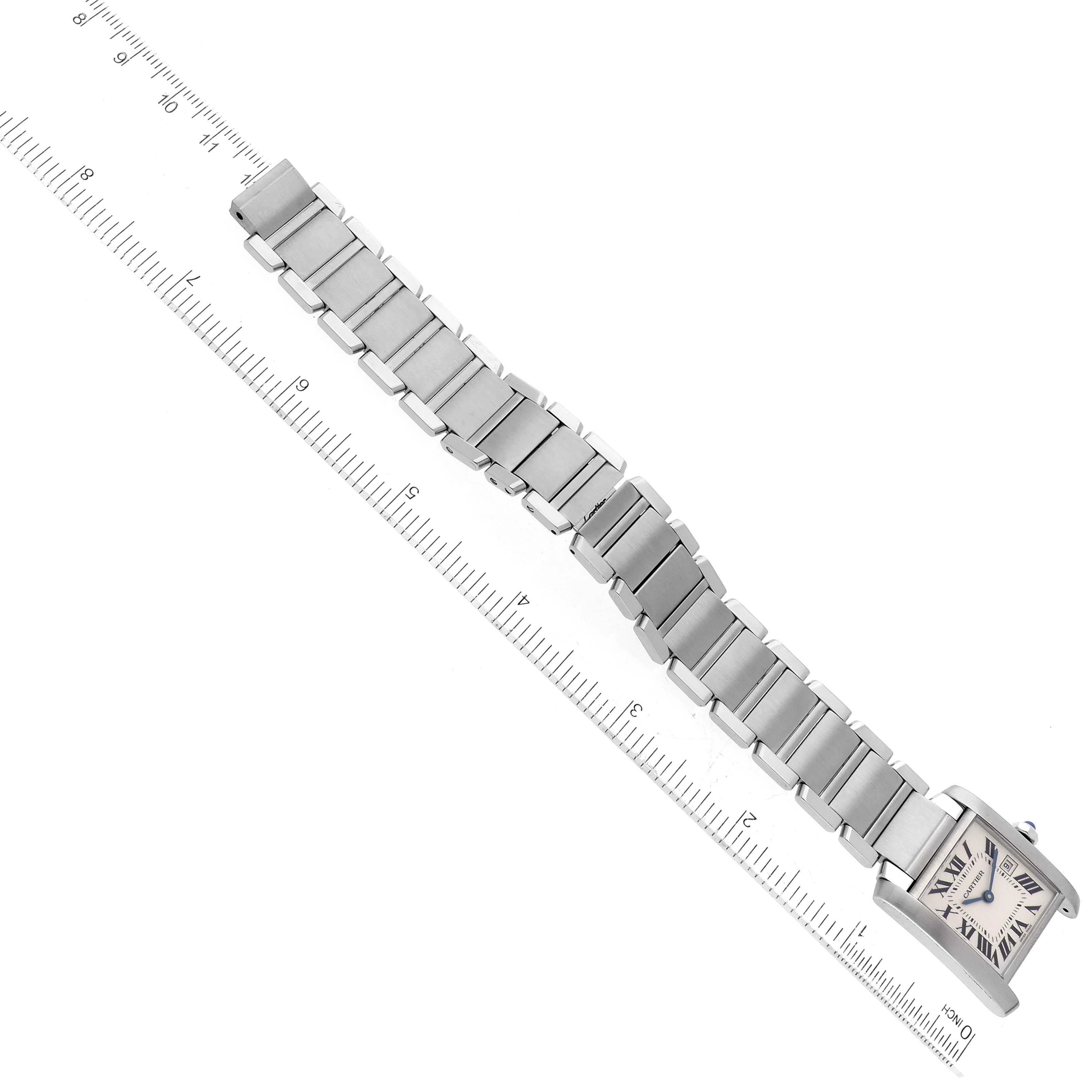 The image shows a Cartier Tank Francaise W51011Q3 Women
s Stainless Steel Silver Dial W51011Q3 Women
s Stainless Steel Silver Dial watch laid flat with its bracelet extended and measured against a ruler.