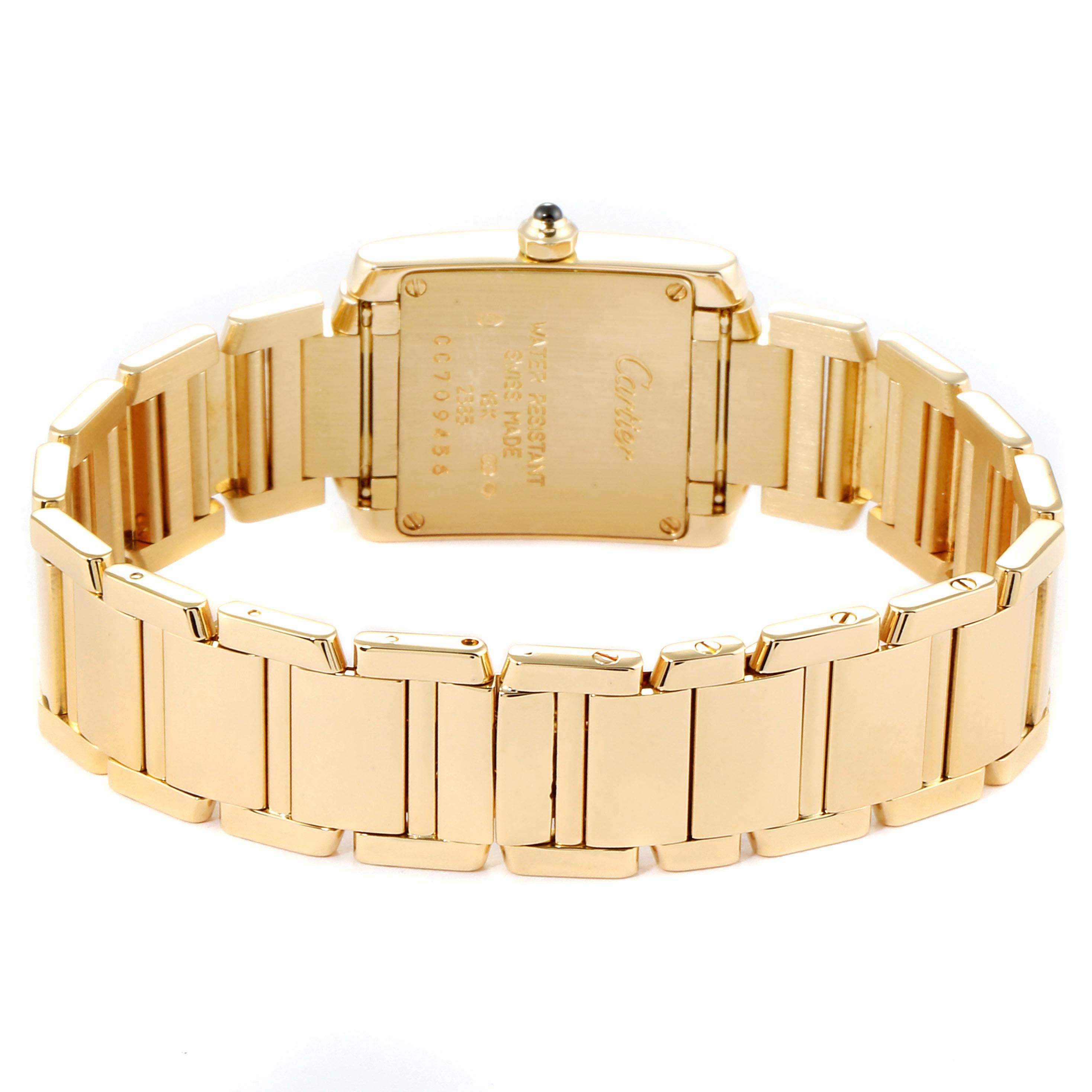 The image shows the back case and bracelet of a Cartier Tank Francaise W50002N2 Women's Yellow Gold Silver Dial W50002N2 Women's Yellow Gold Silver Dial watch, highlighting the engraving and gold links.